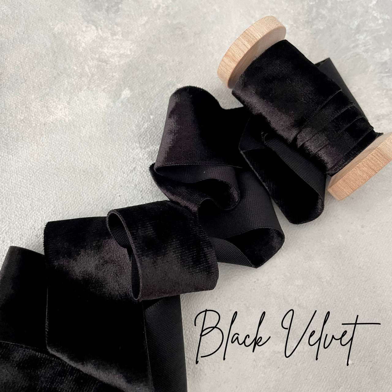Black velvet ribbon on a wood spool