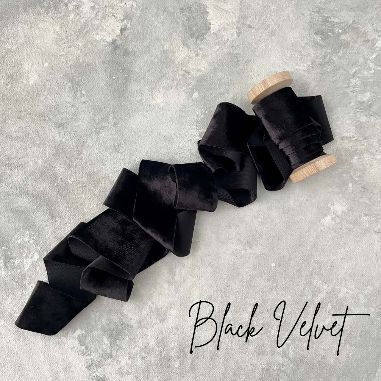 Black velvet ribbon on a wood spool