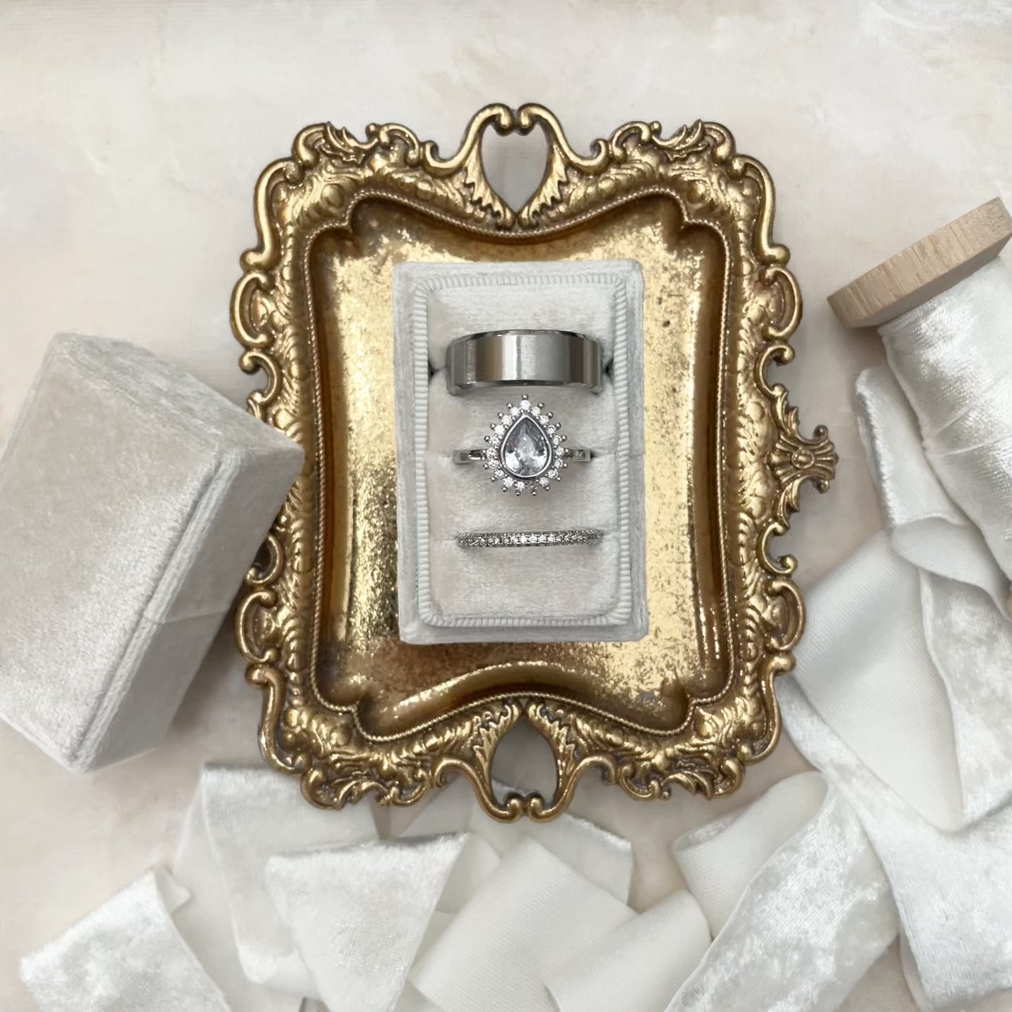 Video close-up of White triple slot ring box on vintage gold tray styled with white ribbon  - Wedding Flat lay props from Champagne & GRIT