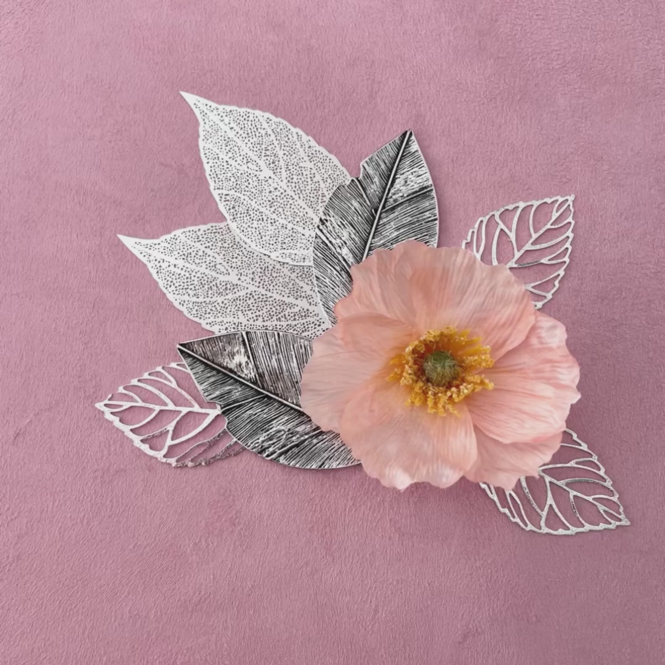 Video of 7 styling leaves including 3 silver leaves, 2 silver leaves that are larger, and 2 large silver with dark accent leaves - wedding flat lay props from Champagne & GRIT