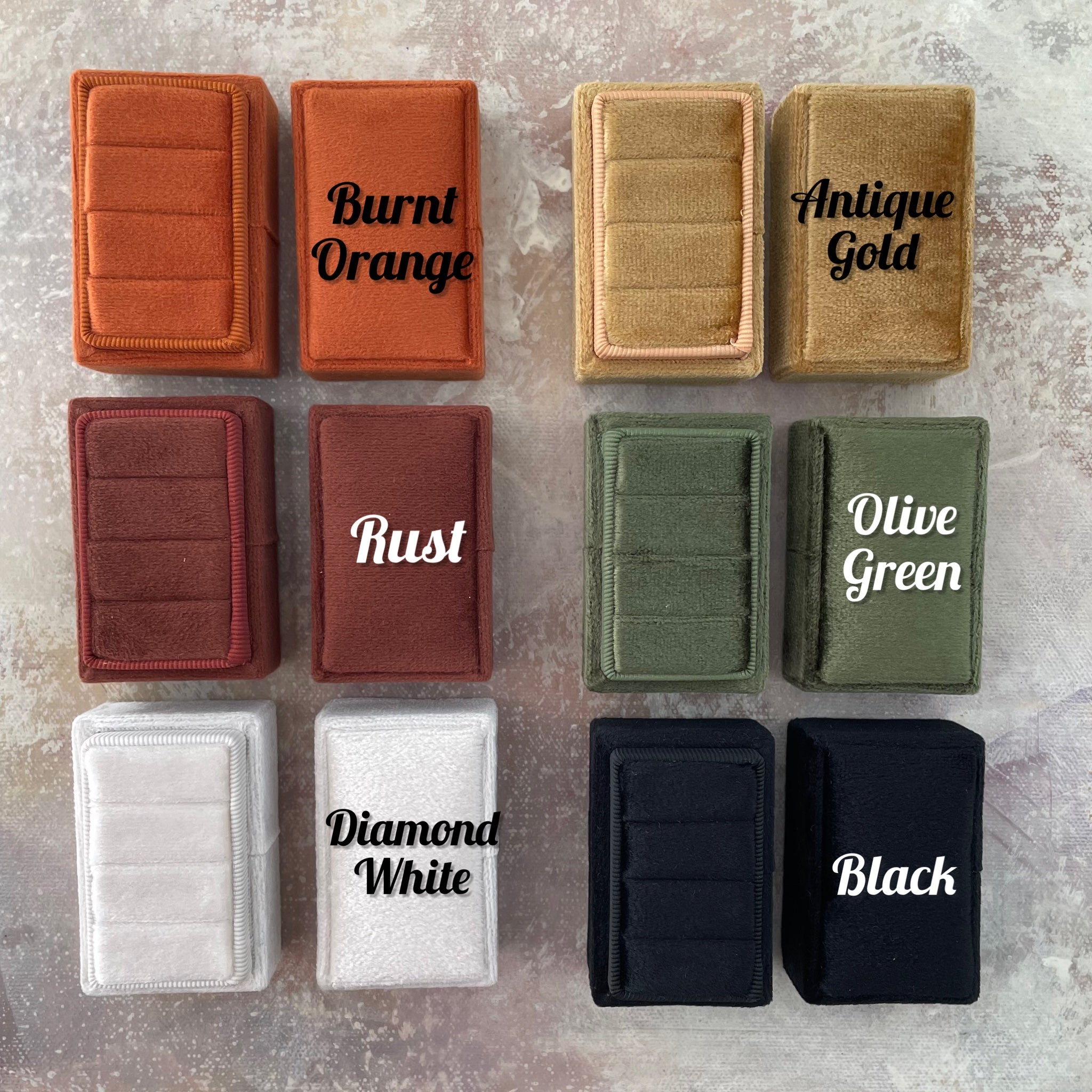 Variety of colored triple slot ring boxes - diamond white, gold, burnt orange, rust, olive green, black - Wedding Flat lay props from Champagne & GRIT