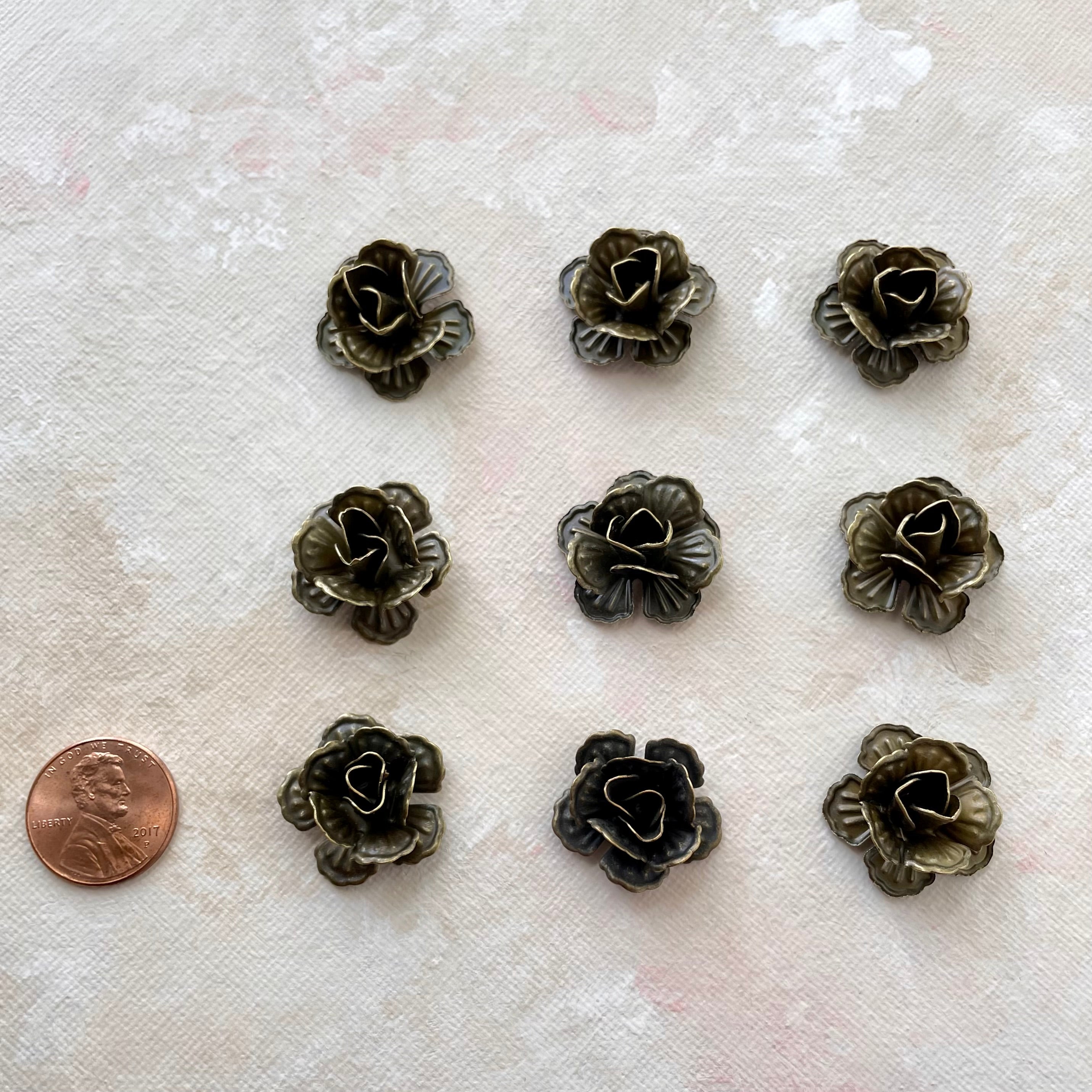 9 small metal styling flower with penny beside for size reference - flat lay props from Champagne & GRIT