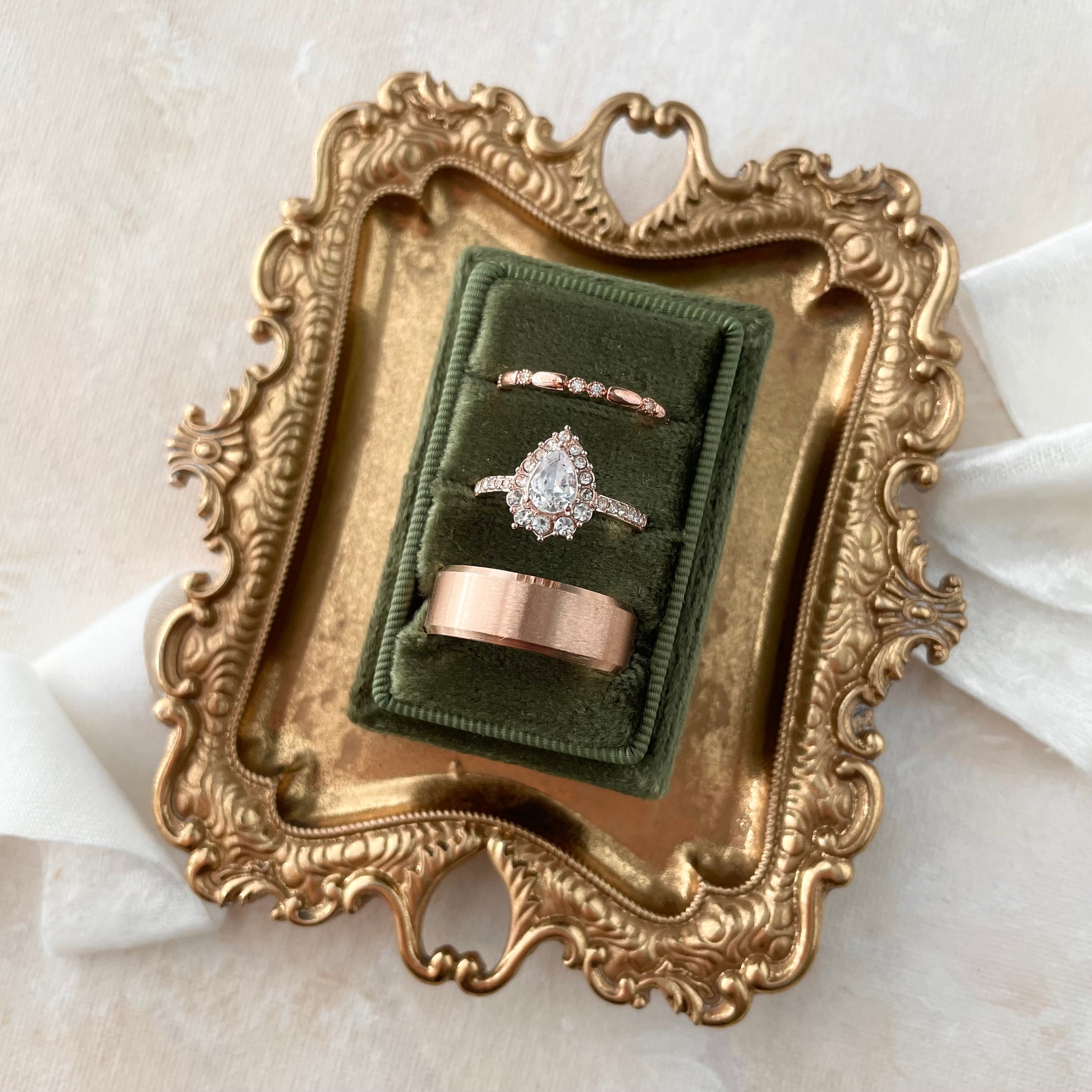 Olive Green tripe slot ring box on vintage gold dish styled with white ribbon  - Wedding Flat lay props from Champagne & GRIT