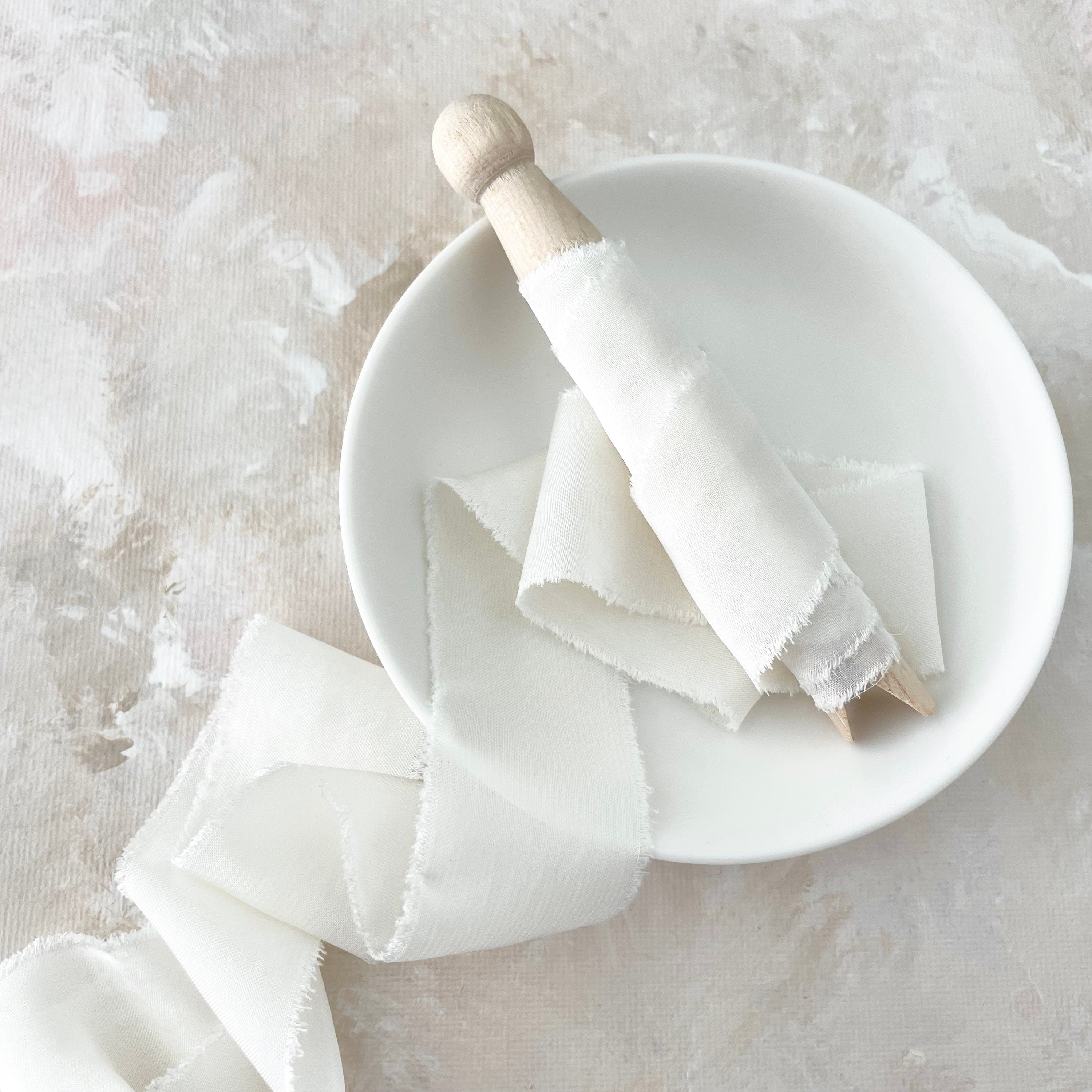 IVORY silk satin ribbon on wood pin in white tray - flat lay props from Champagne & GRIT