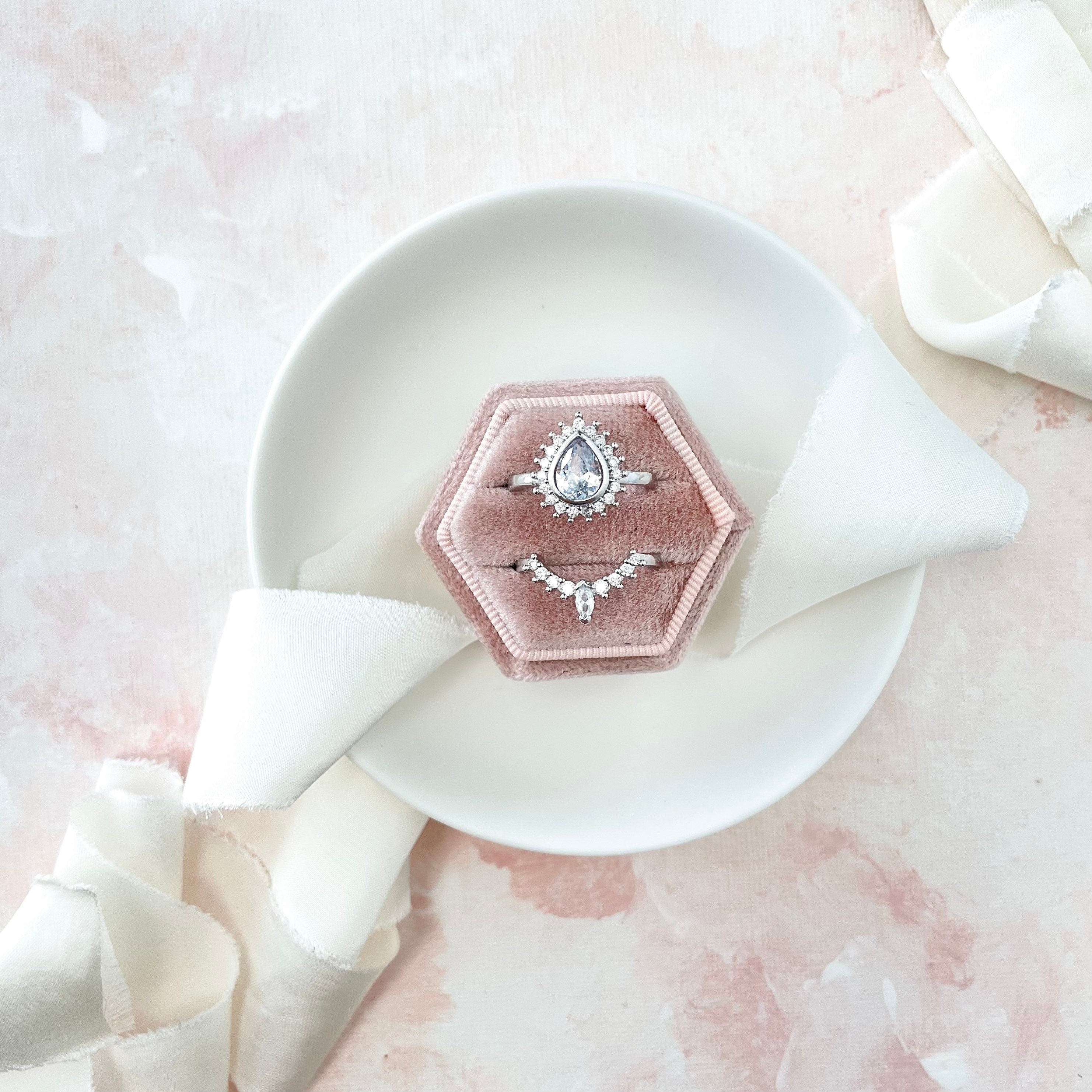 Dusty pink ring box in white tray styled with Ivory ribbon  - flat lay props from Champagne & GRIT