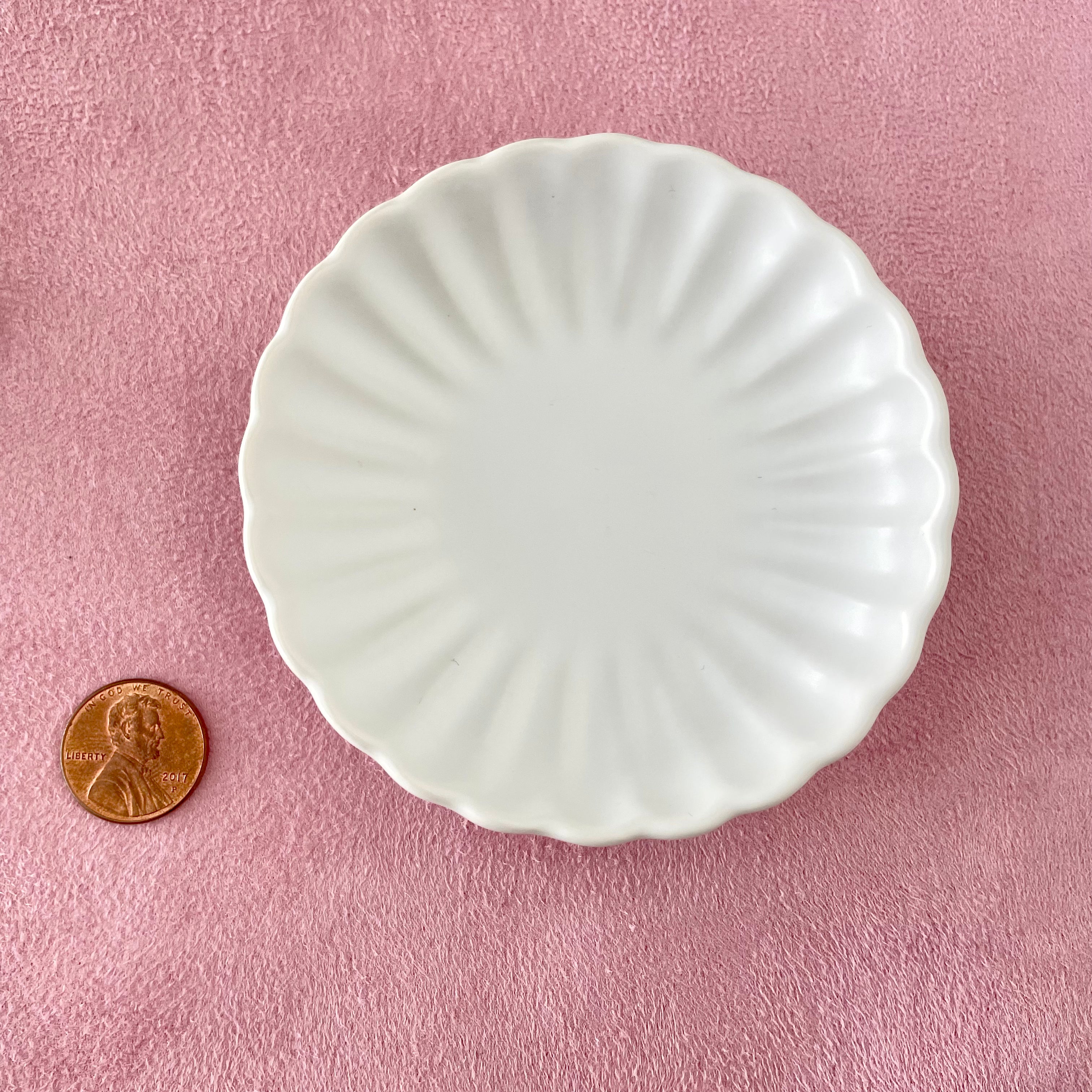 Matte white scalloped dish with penny beside for size reference - wedding flat lay props from Champagne & GRIT
