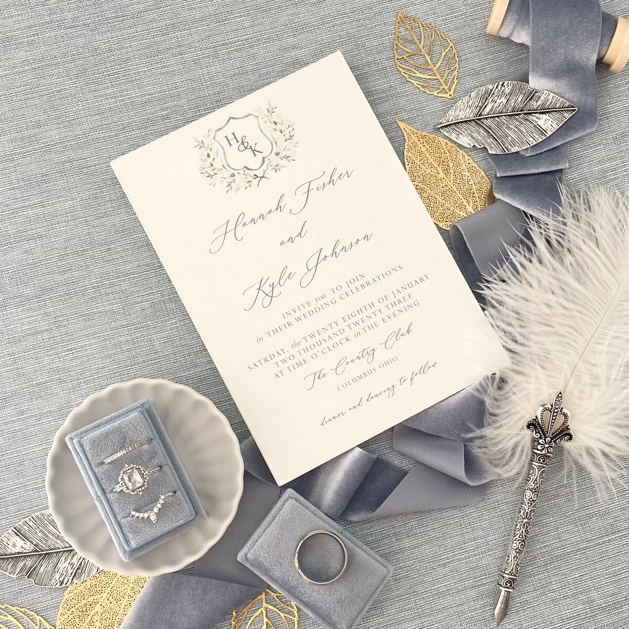 Dusty Blue 3 slot ring box styled with wedding invitation, dusty blue ribbon and vintage silver pen - Wedding Flat lay props from Champagne & GRIT