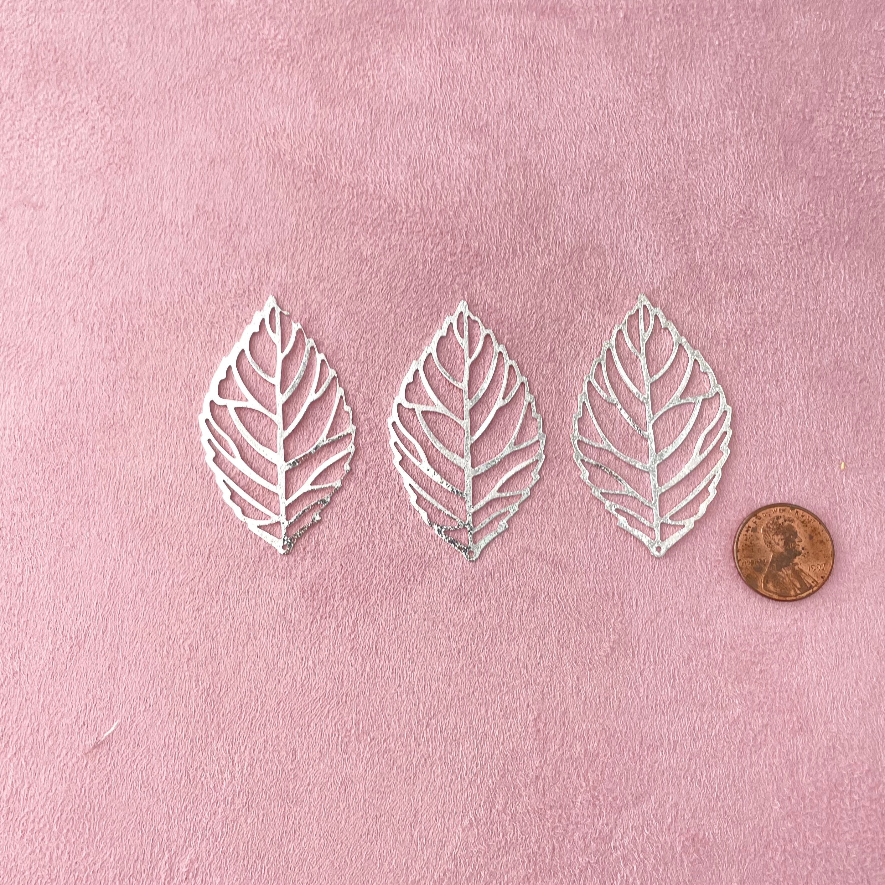 3 silver styling leaves with penny beside for size reference - wedding flat lay props from Champagne & GRIT