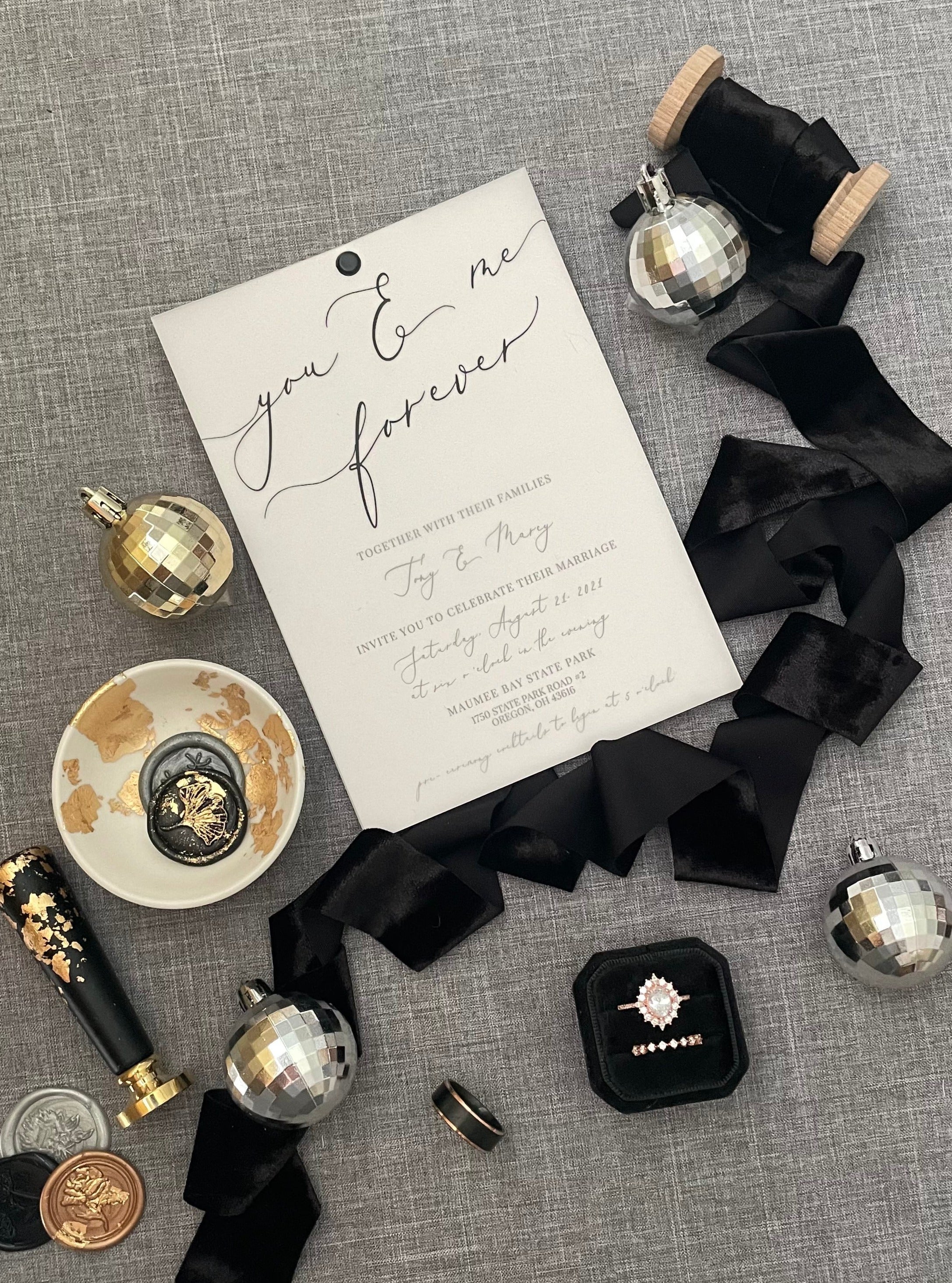 Black velvet ribbon styled with black ring box, wedding invitation, and wax stamps  -  Wedding Flat lay props from Champagne & GRIT