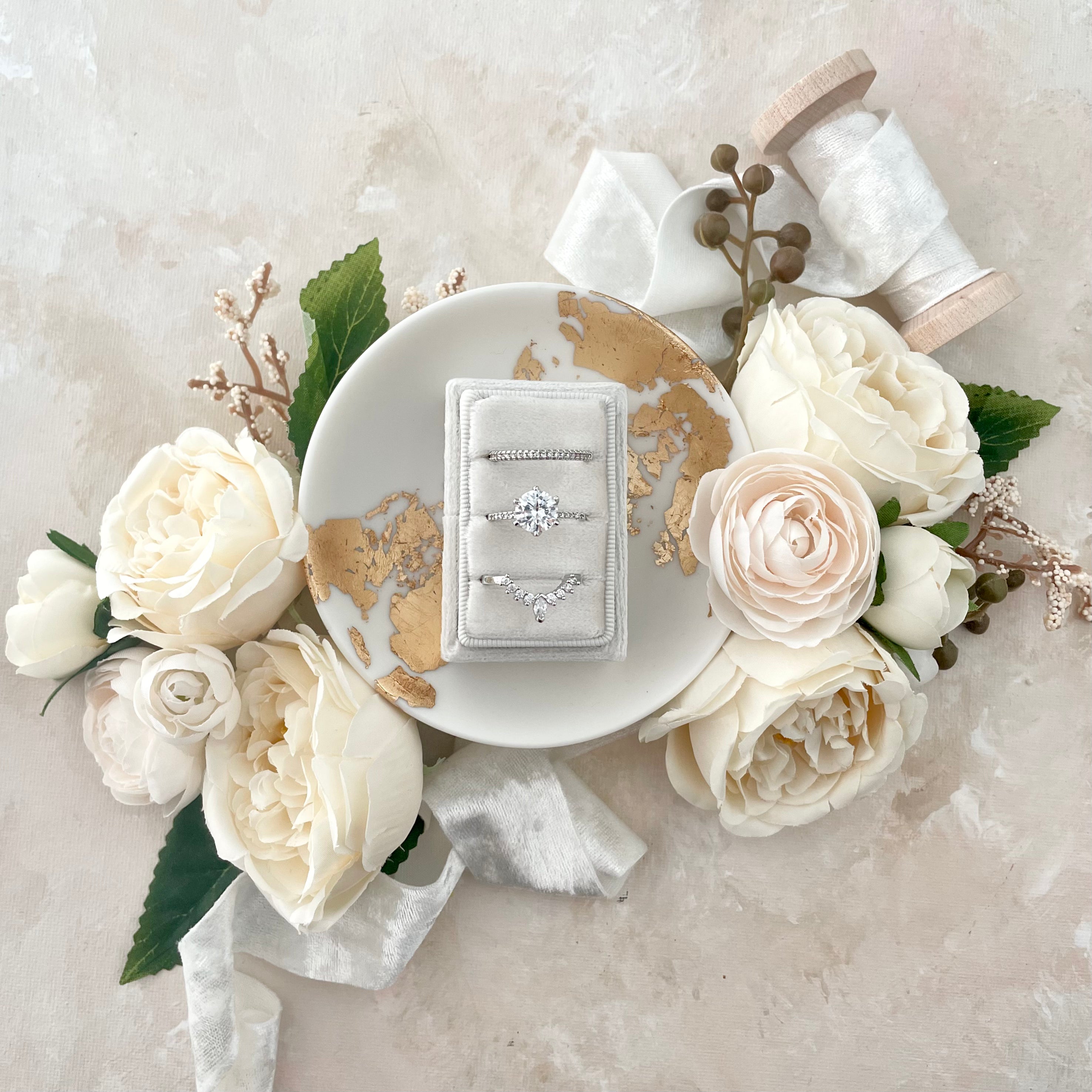 White triple slot ring box in white dish with white velvet ribbon  -  Wedding Flat lay props from Champagne & GRIT