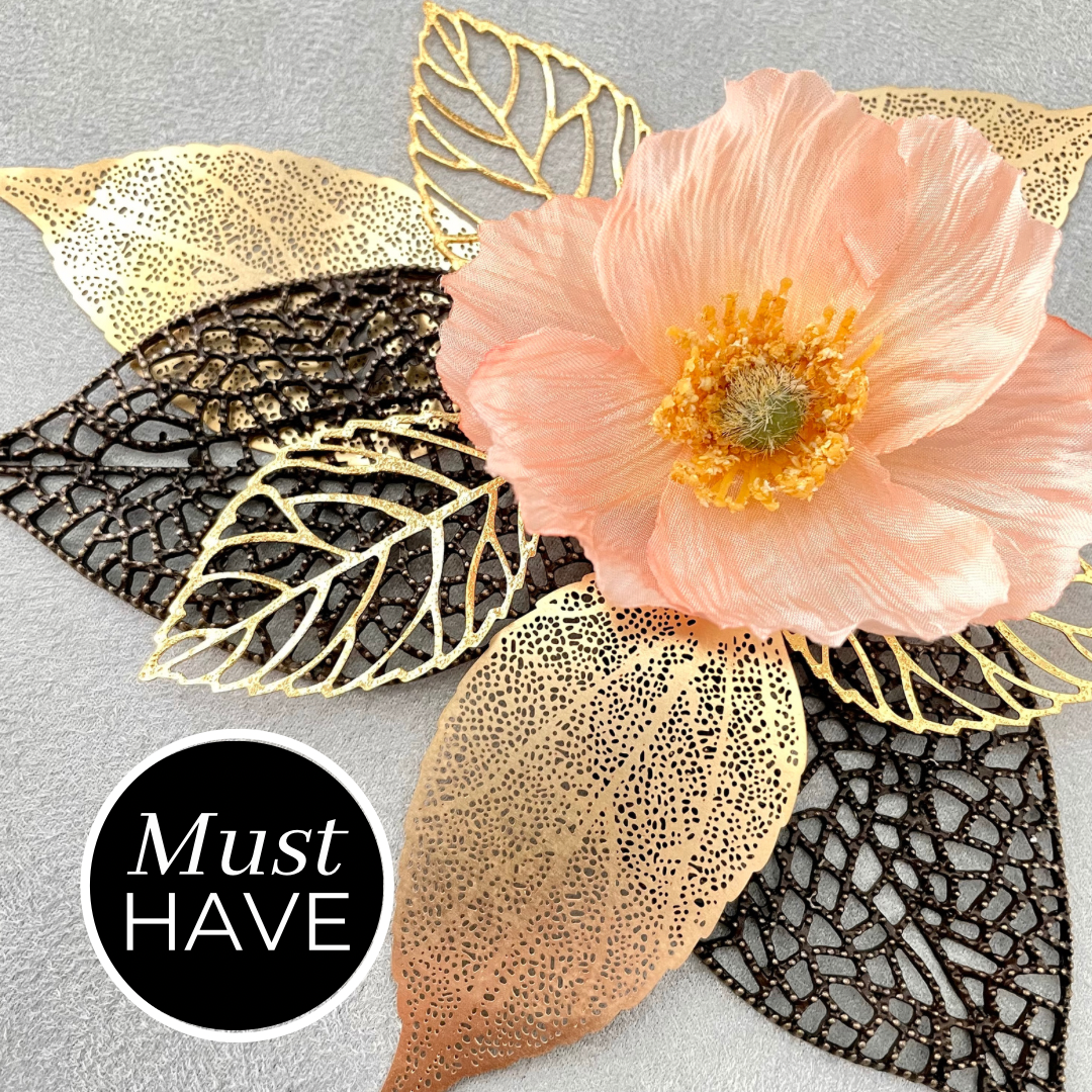 8 styling leaves including 3 gold leaves, 3 gold leaves that are larger, and 2 large coco bronze leaves with one floral accent on top - wedding flat lay props from Champagne & GRIT