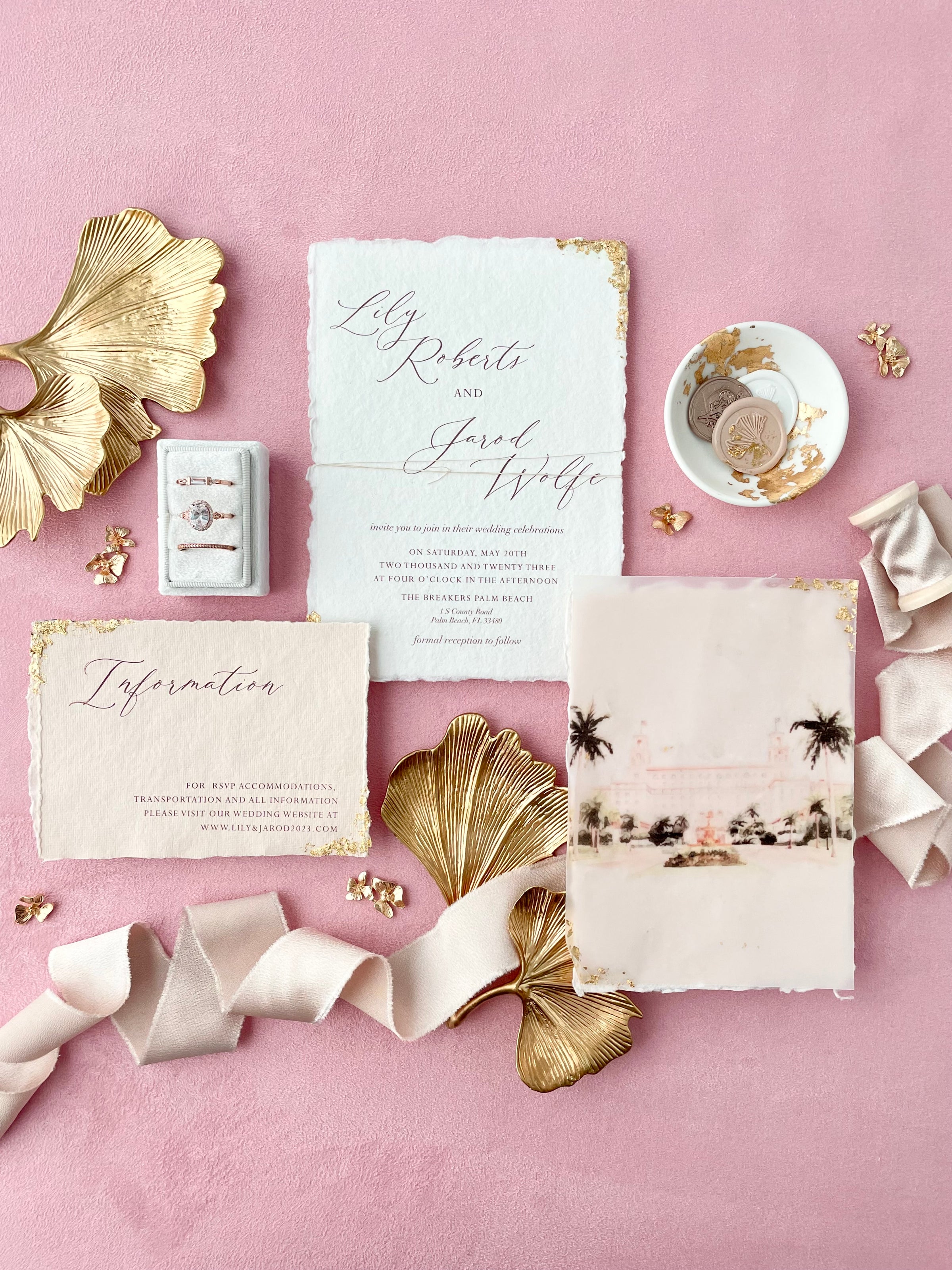 Gold, white and blush flat lay styling kit on a dusty pink styling mat  