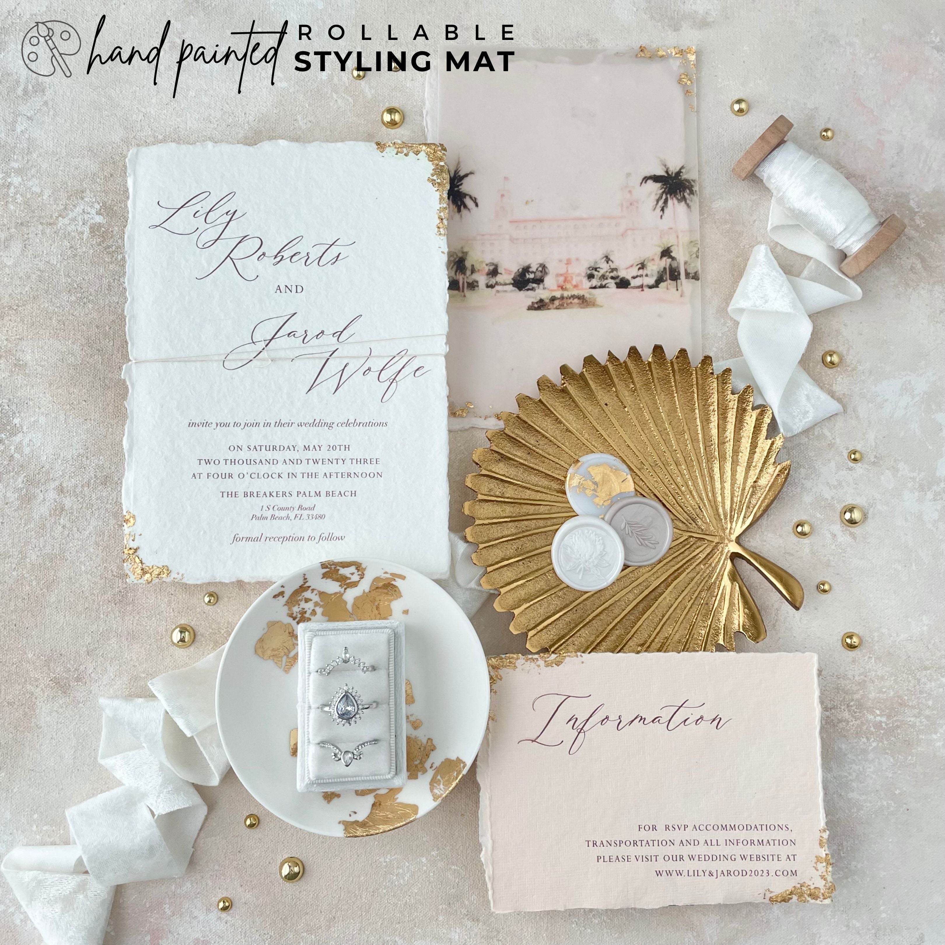 modern glam wedding invitation, styled on a neutral hand painted rollable Flat lay backdrop. Featuring a gold ring dish & white Velvet Ribbon with a 3 Slot Ring Box