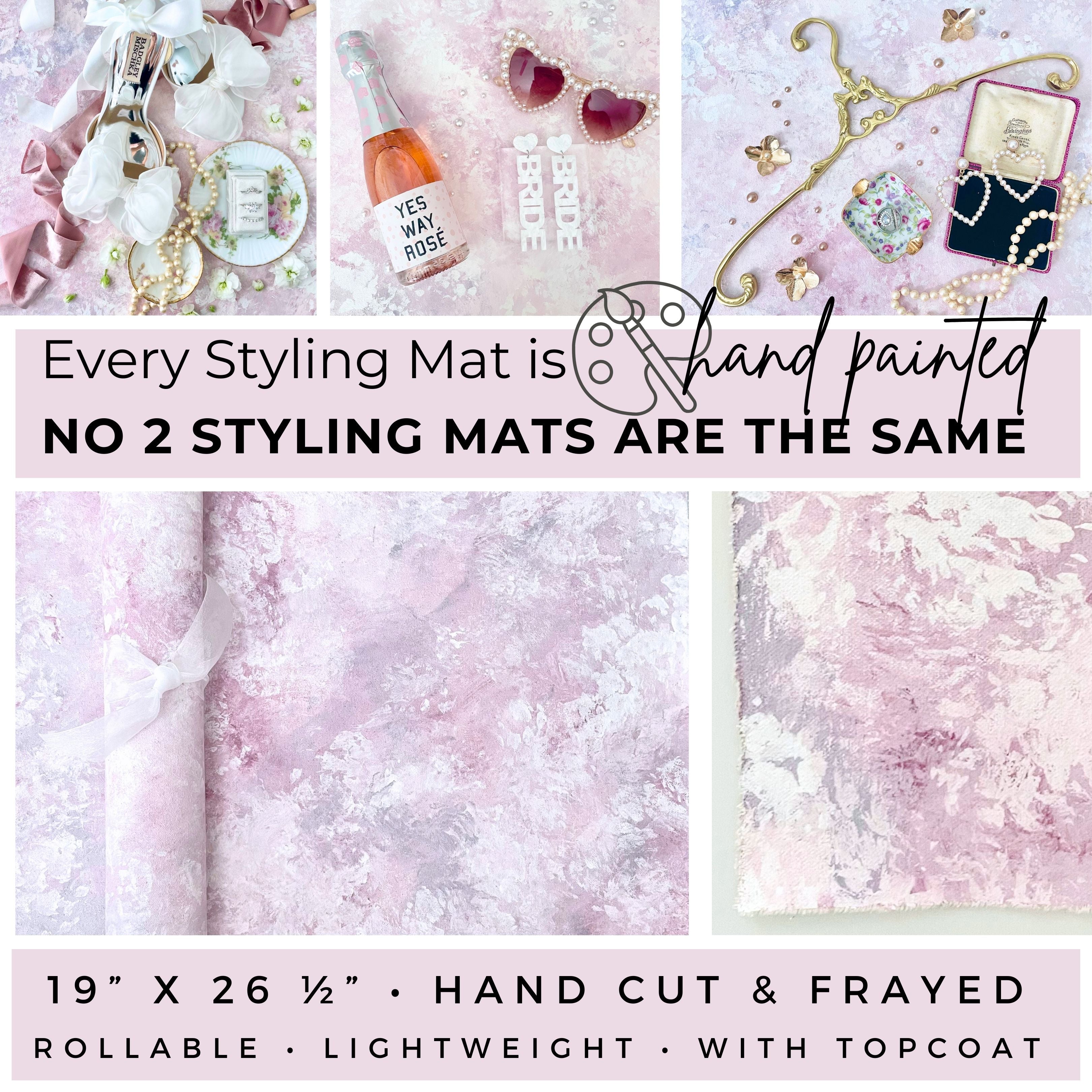 Every Flat Lay Styling Mat is hand painted no 2 Styling backdrops are the same.  FlatLay Mats are Hand Cut & frayed 19” x 26 ½”, rollable, lightweight, with top coat.  Mauve Pink & Lavender painted Flat Lay Styling Mat. Examples of Wedding Flat lay lay details