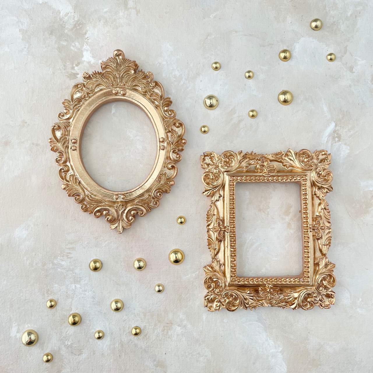 mini gold vintage inspired flat lay props for photographers on a tan background with small gold pearls