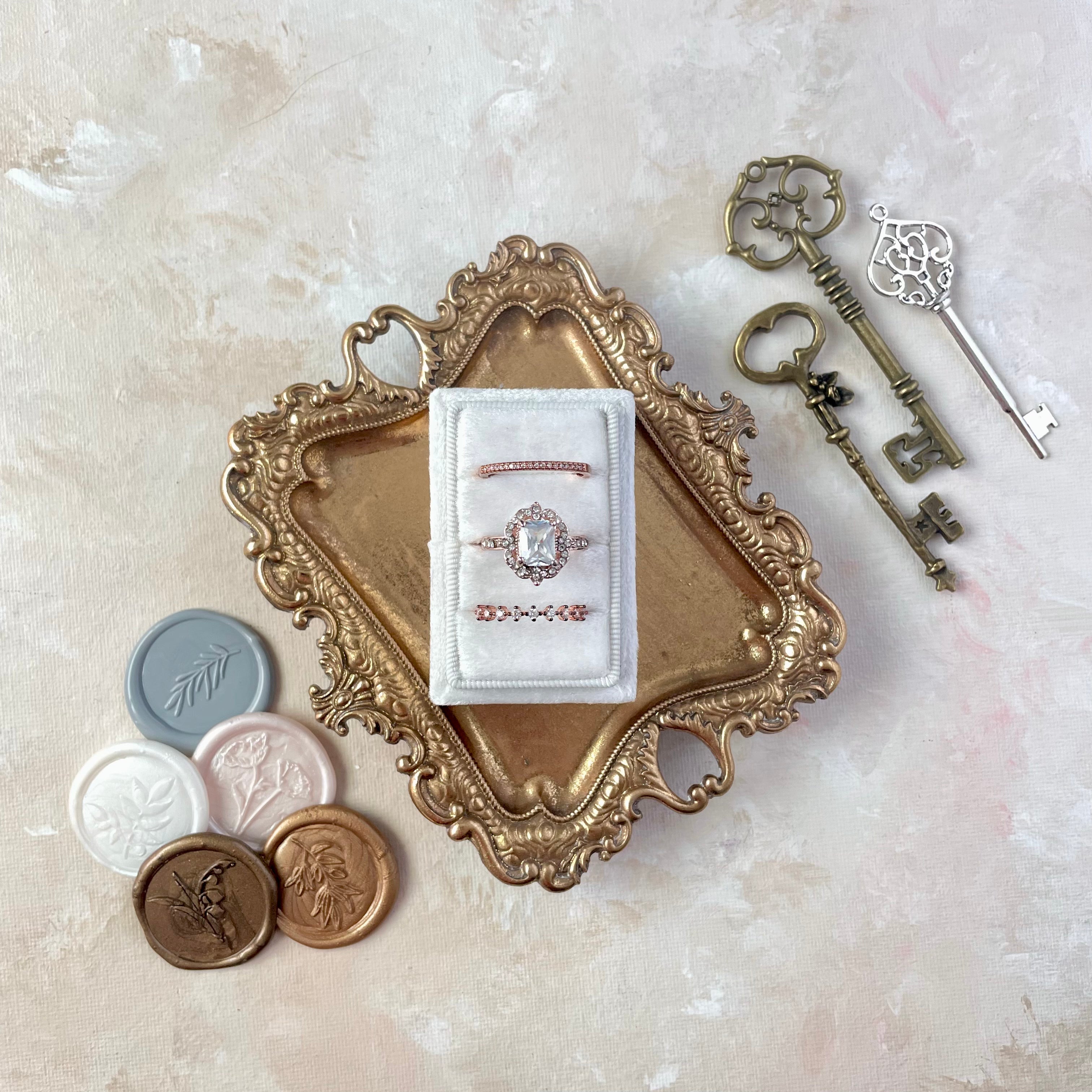 5 Classic neutral color pallet Wax Seals styled beside white 3 slot ring box on gold tray and three vintage keys - wedding flat lay props from Champagne & GRIT