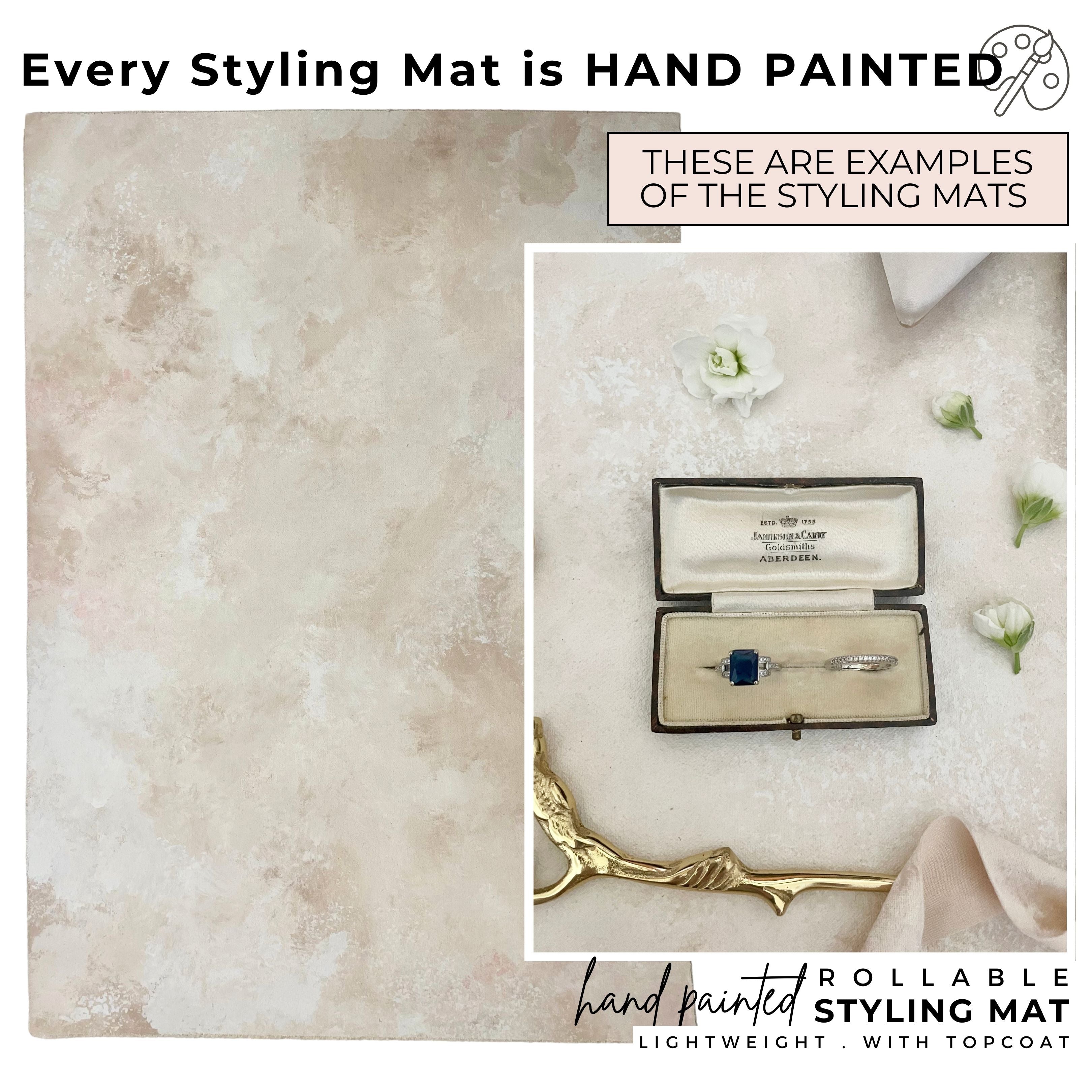 Every Styling Mat is Hand Painted, these are examples of the rollable Styling mats .  The Styling Mat featured is a tan, and taupe and showcases a Vintage Ring Box with Blue Diamond RIng