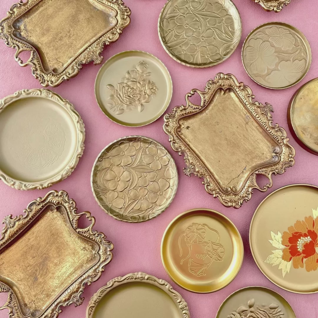 Close up video of 8 vintage gold ring dishes and trays for flat lays from Champagne & GRIT