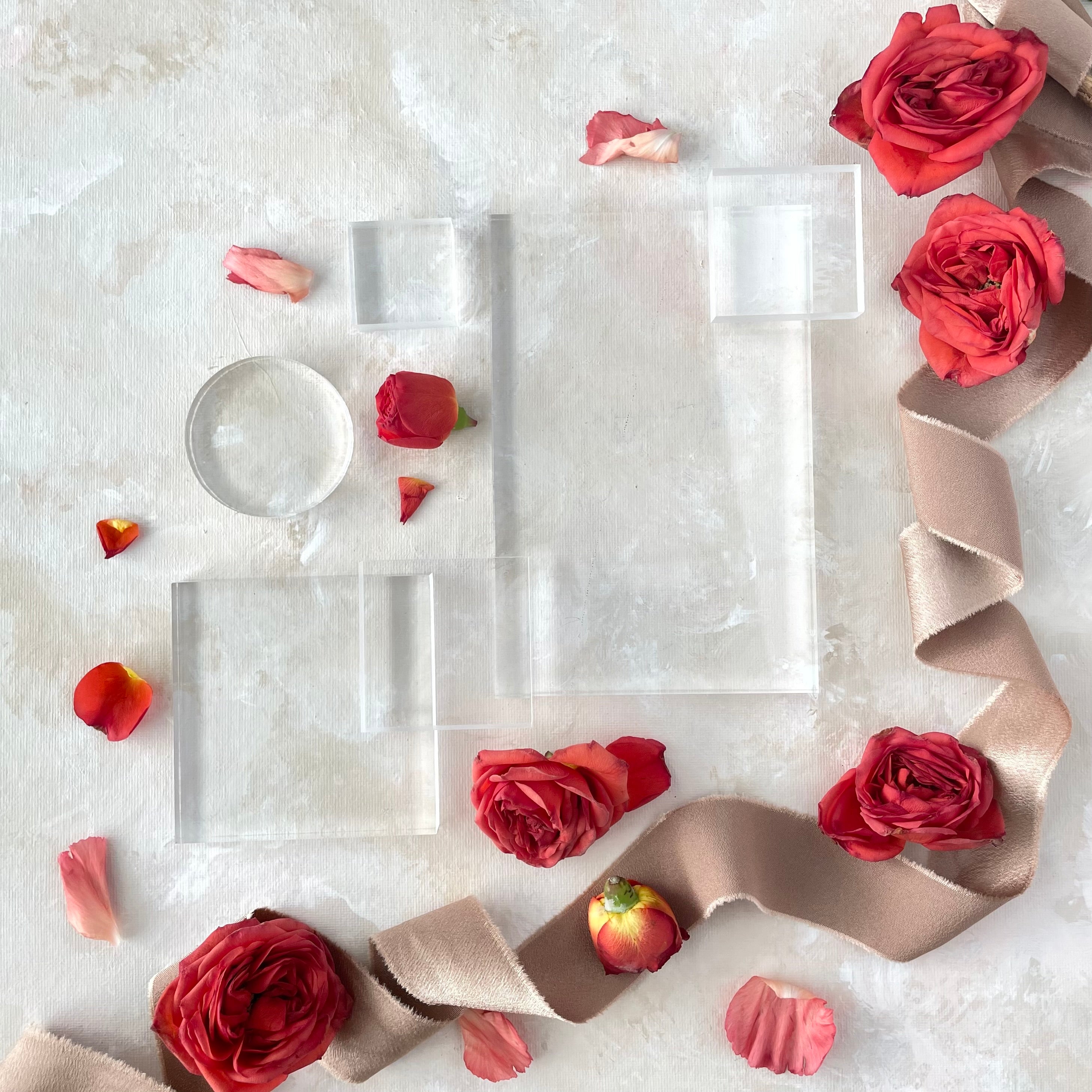 Clear Acrylic Styling Block Set including 4 different sized squares, one large rectangle, and one circle - styled with tan ribbon and roses - Flat Lays from Champagne & GRIT