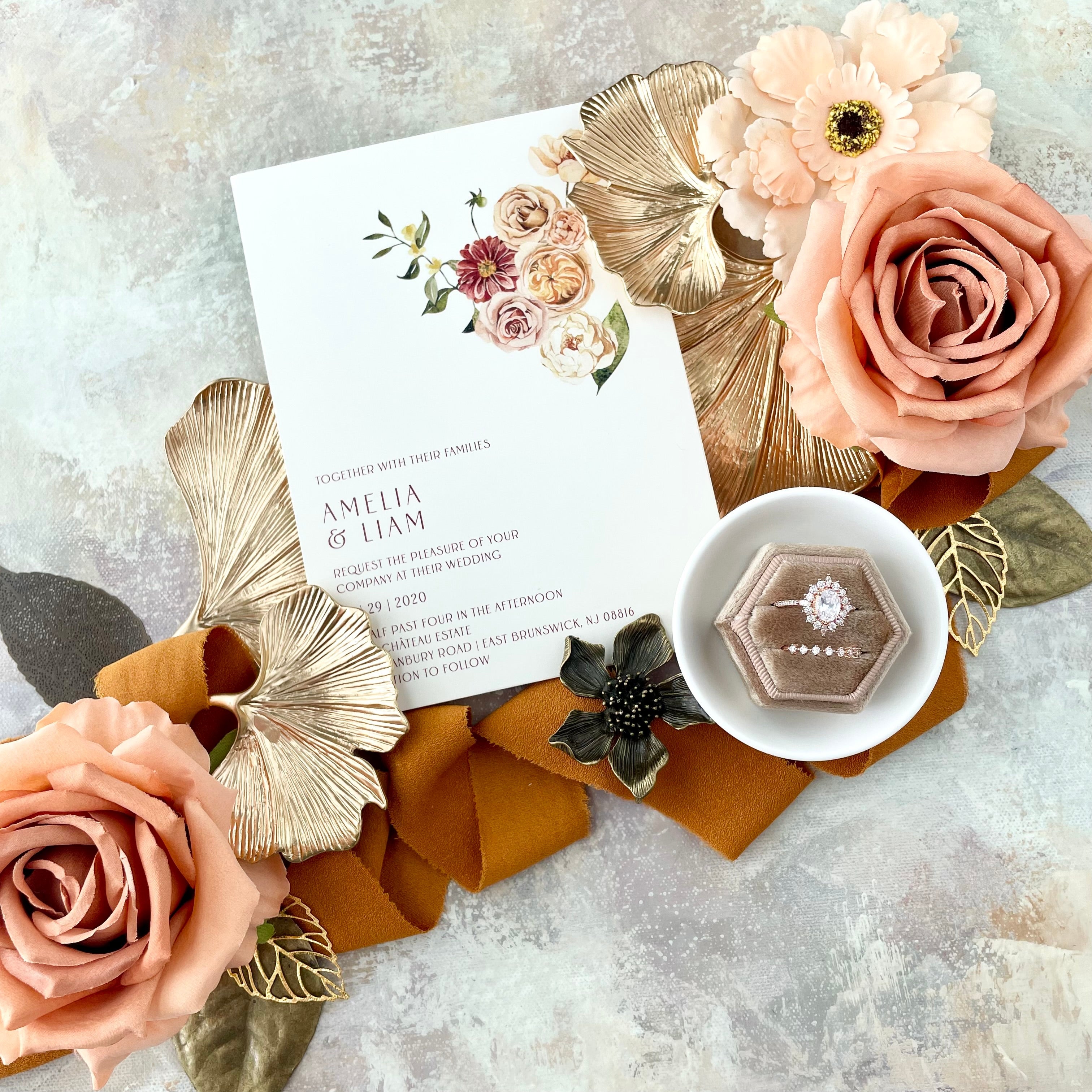 Ginkgo Leaf Gold Styling Tray styled with floral wedding invitation, tan ring box, orange ribbon, and blush florals - Flat Lay Props from Champagne & GRIT