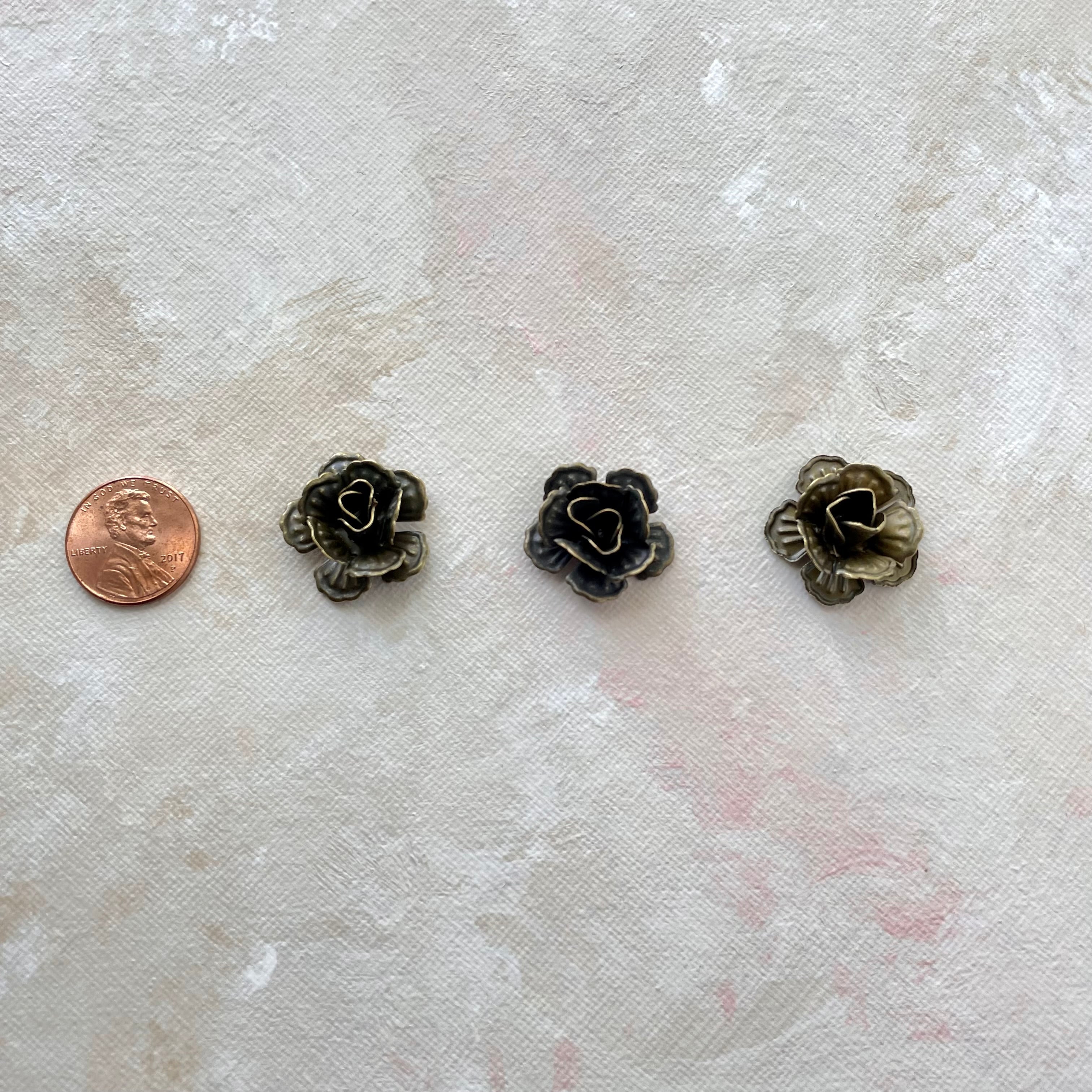 3 small metal styling flower with penny beside for size reference - flat lay props from Champagne & GRIT