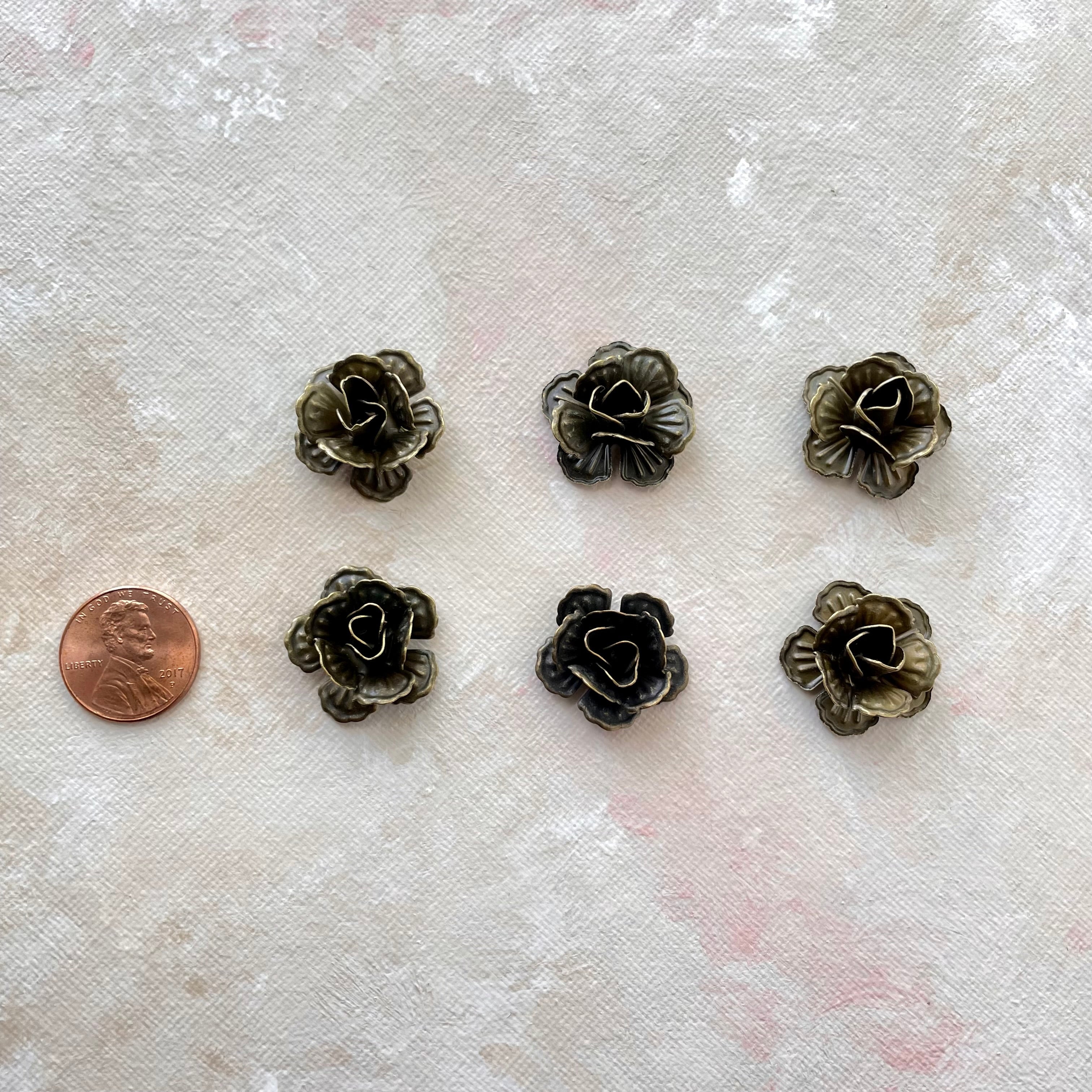 6 small metal styling flower with penny beside for size reference - flat lay props from Champagne & GRIT