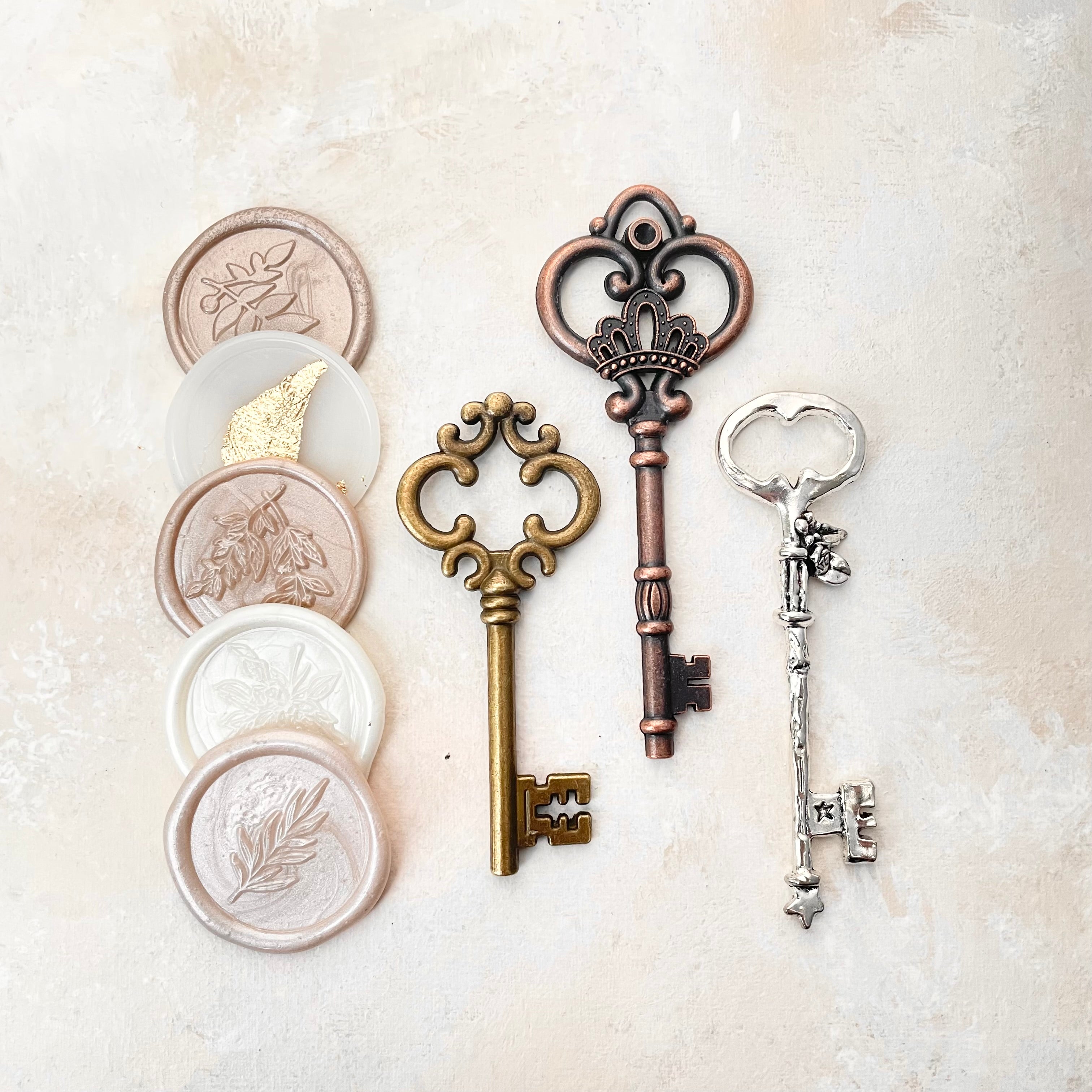 3 keys, gold, bronze and silver and 5 champagne wax seals - Wedding Flat lay props from Champagne & GRIT