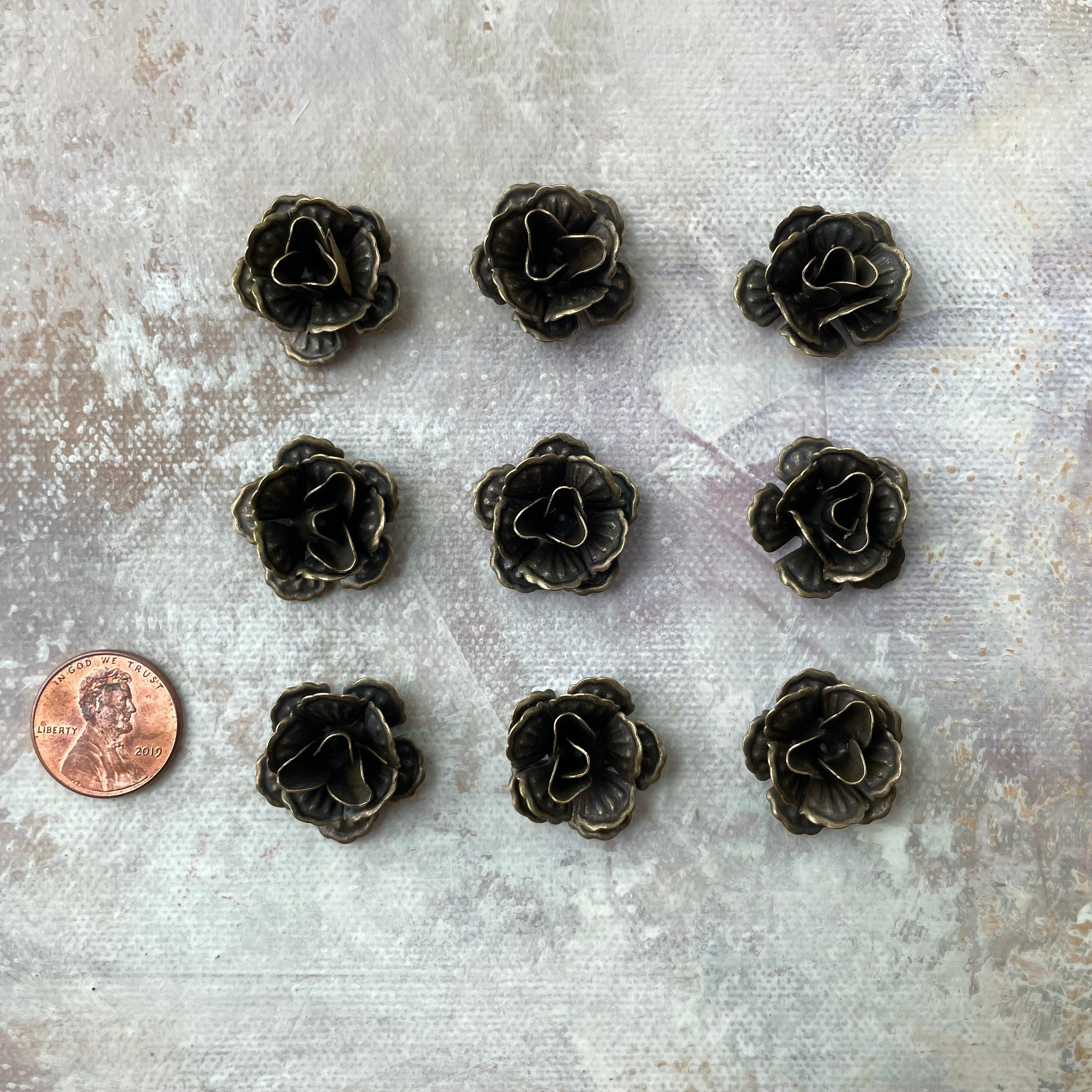 9 mini bronze styling flowers with penny beside for size reference - Flat lay props from Champagne & GRIT