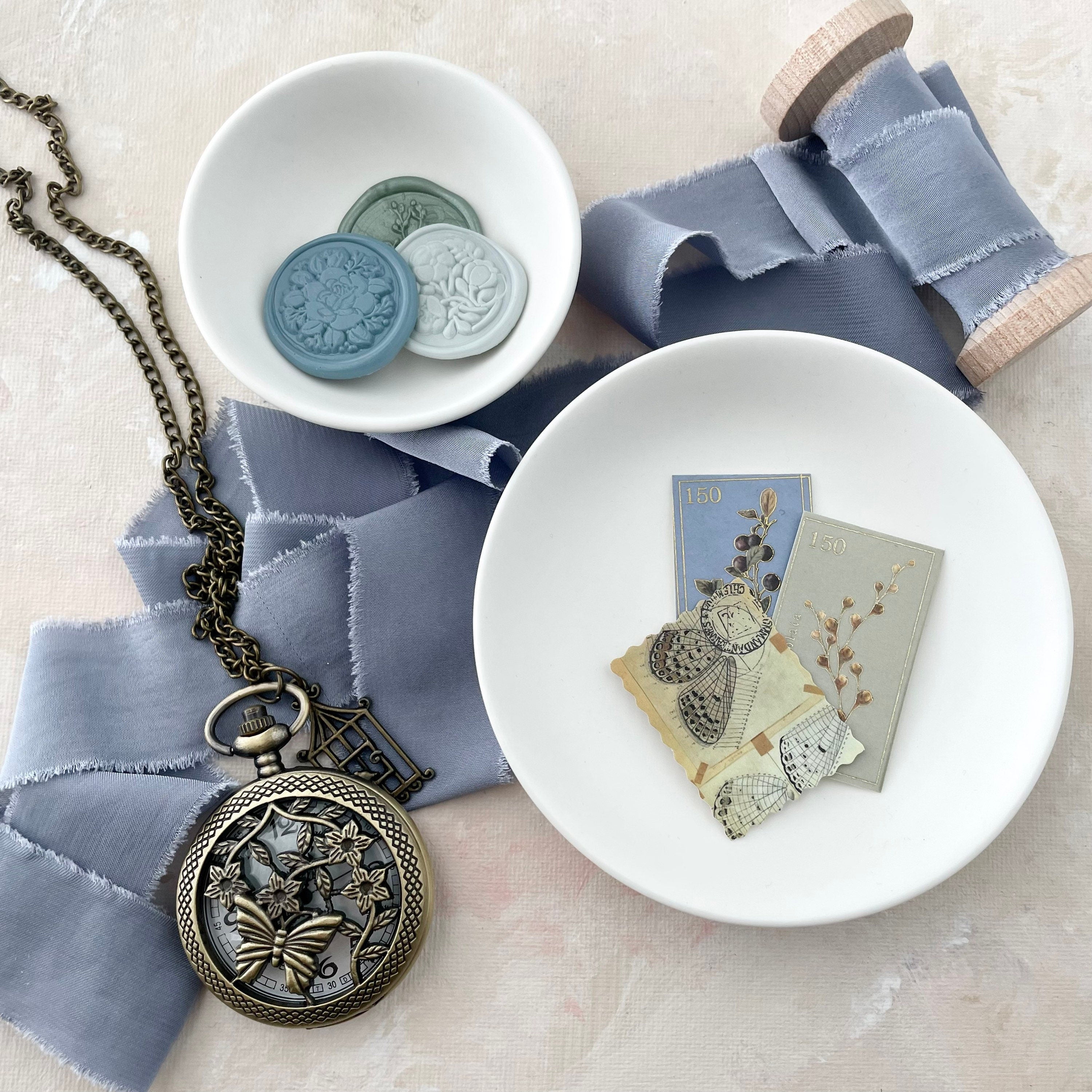 Dusty Blue Ribbon, styled with 3 wax seals in white tray, 3 vintage stamps, and vintage pocket watch - wedding flat lay props from Champagne & GRIT
