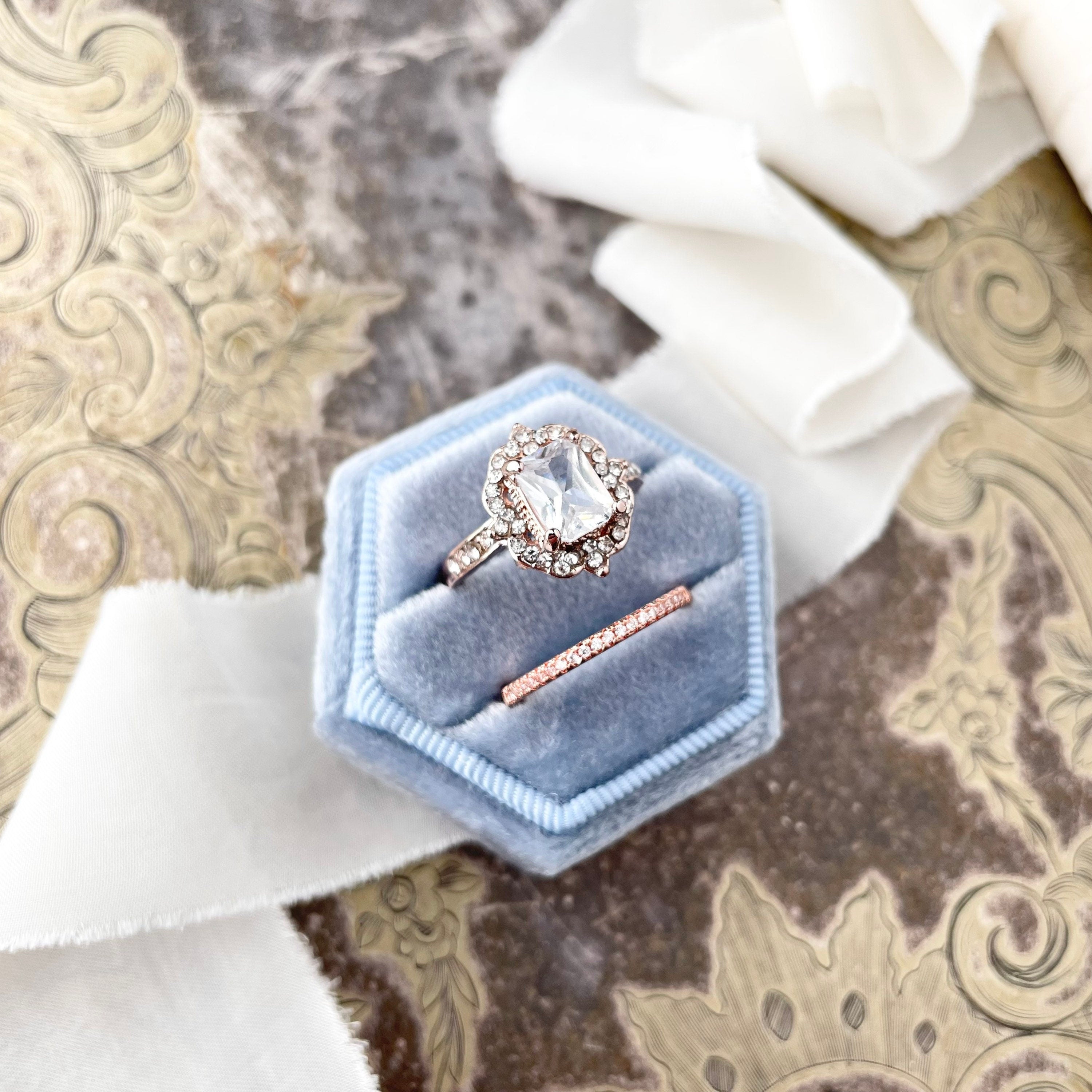Dusty blue ring box styled with Ivory ribbon  - flat lay props from Champagne & GRIT