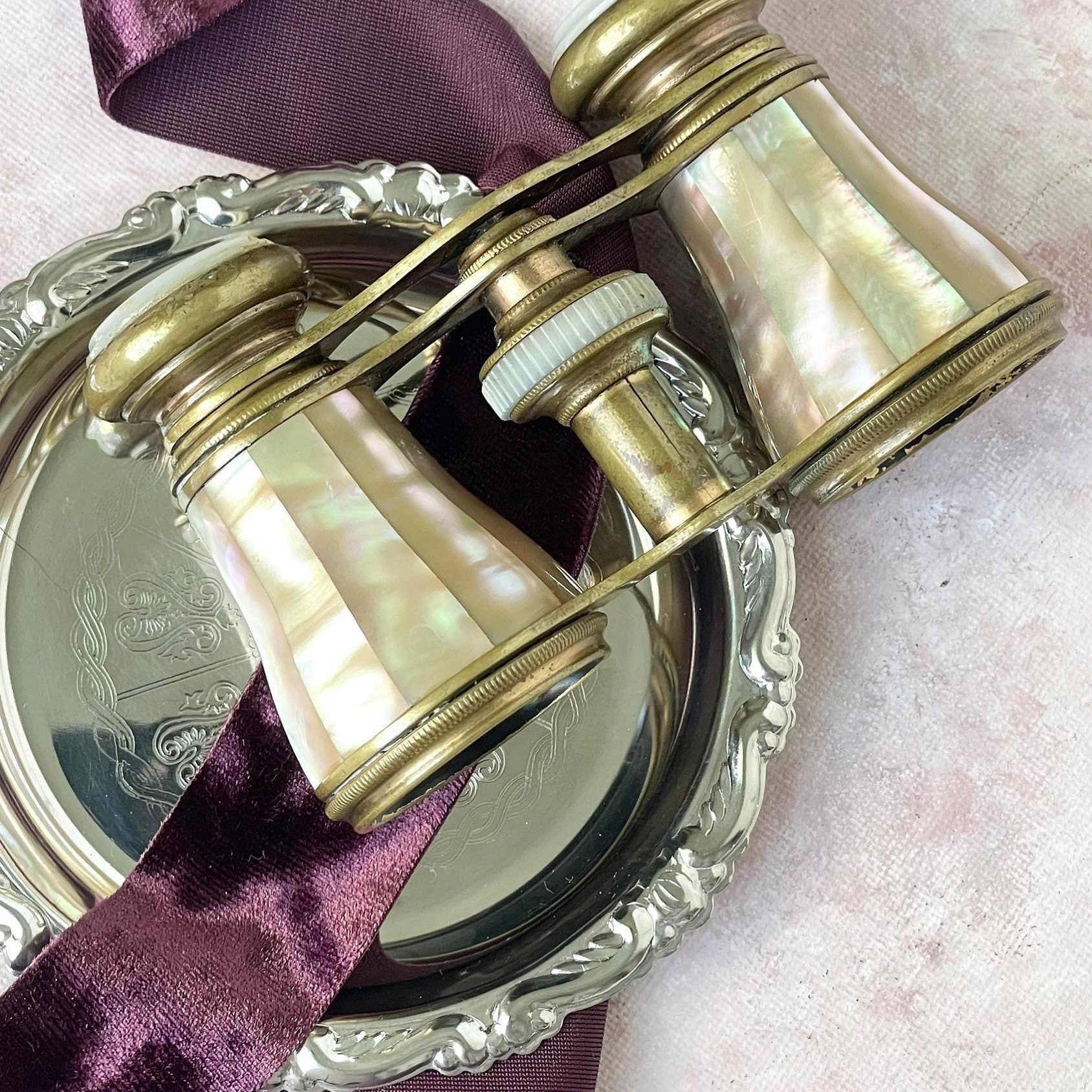 Vintage opera glasses on silver fish and plum ribbon - Flat lay props from Champagne & GRIT