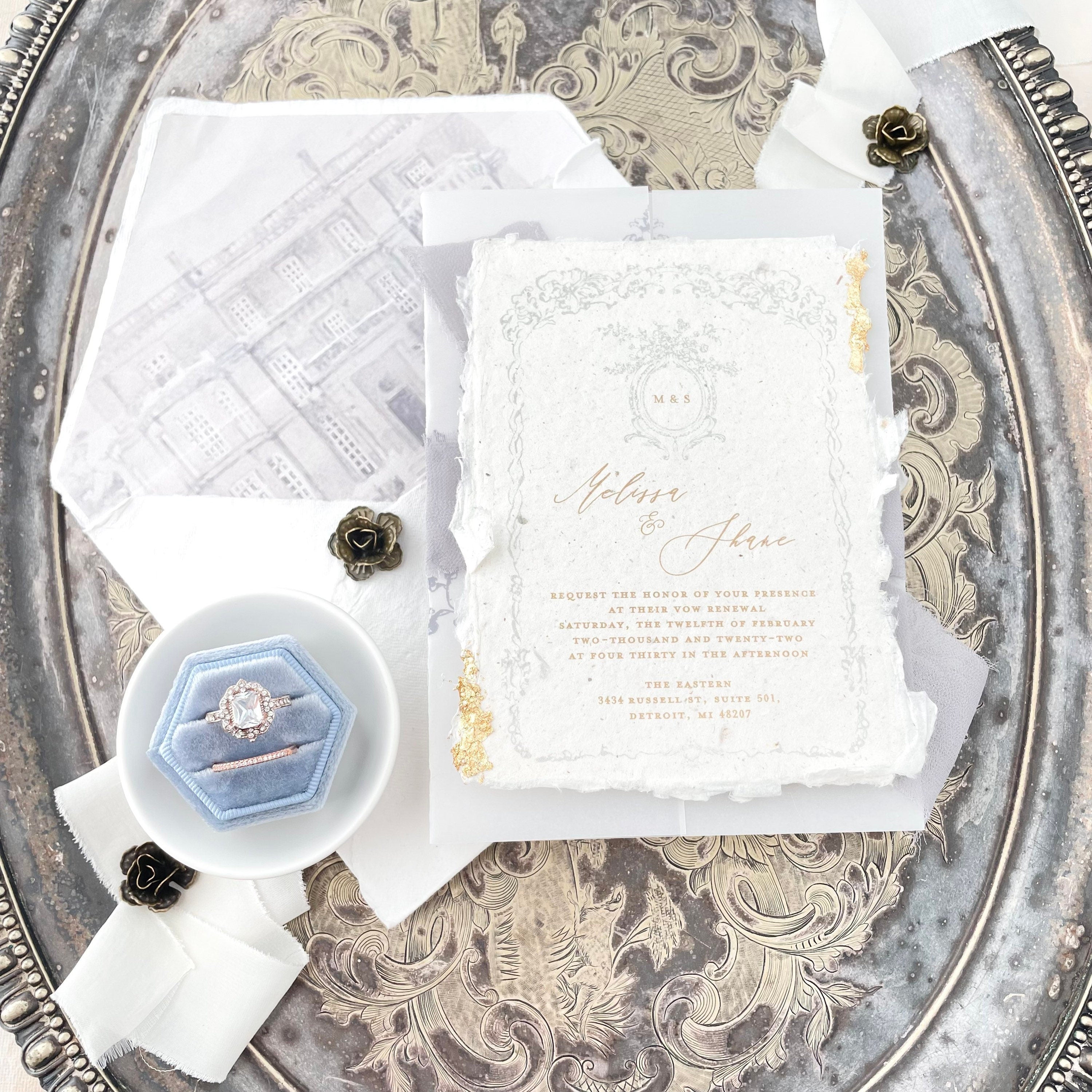 Vintage white and gold wedding invitation, dusty blue ring box in white tray styled with Ivory ribbon  - flat lay props from Champagne & GRIT