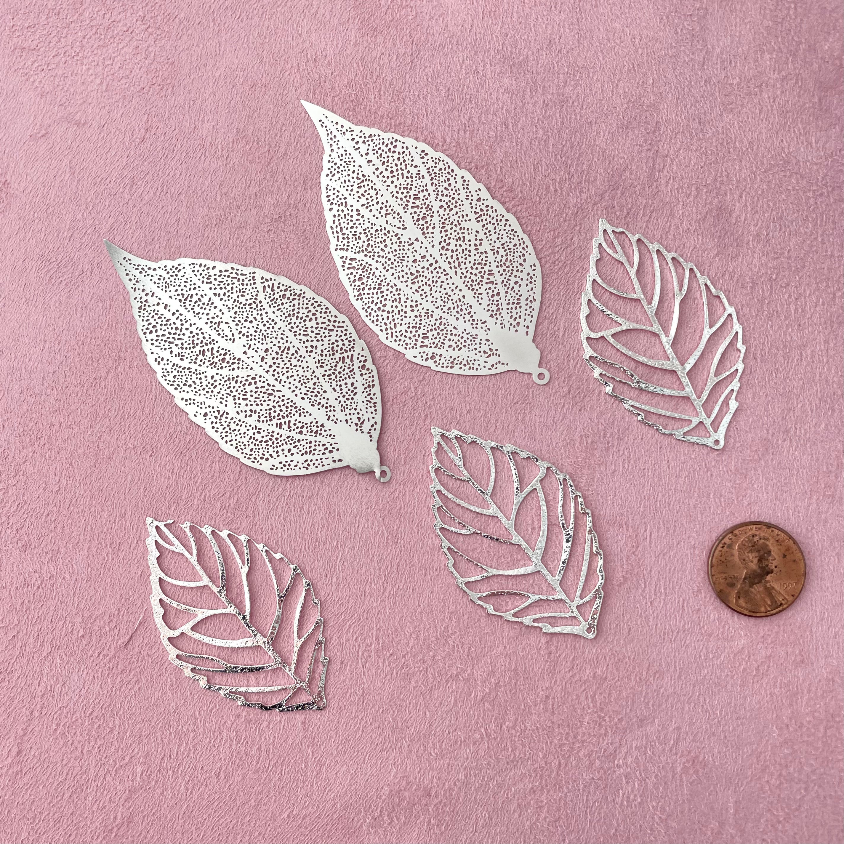 5 styling leaves including 3 silver leaves, 2 silver leaves that are larger with penny beside for size reference - wedding flat lay props from Champagne & GRIT