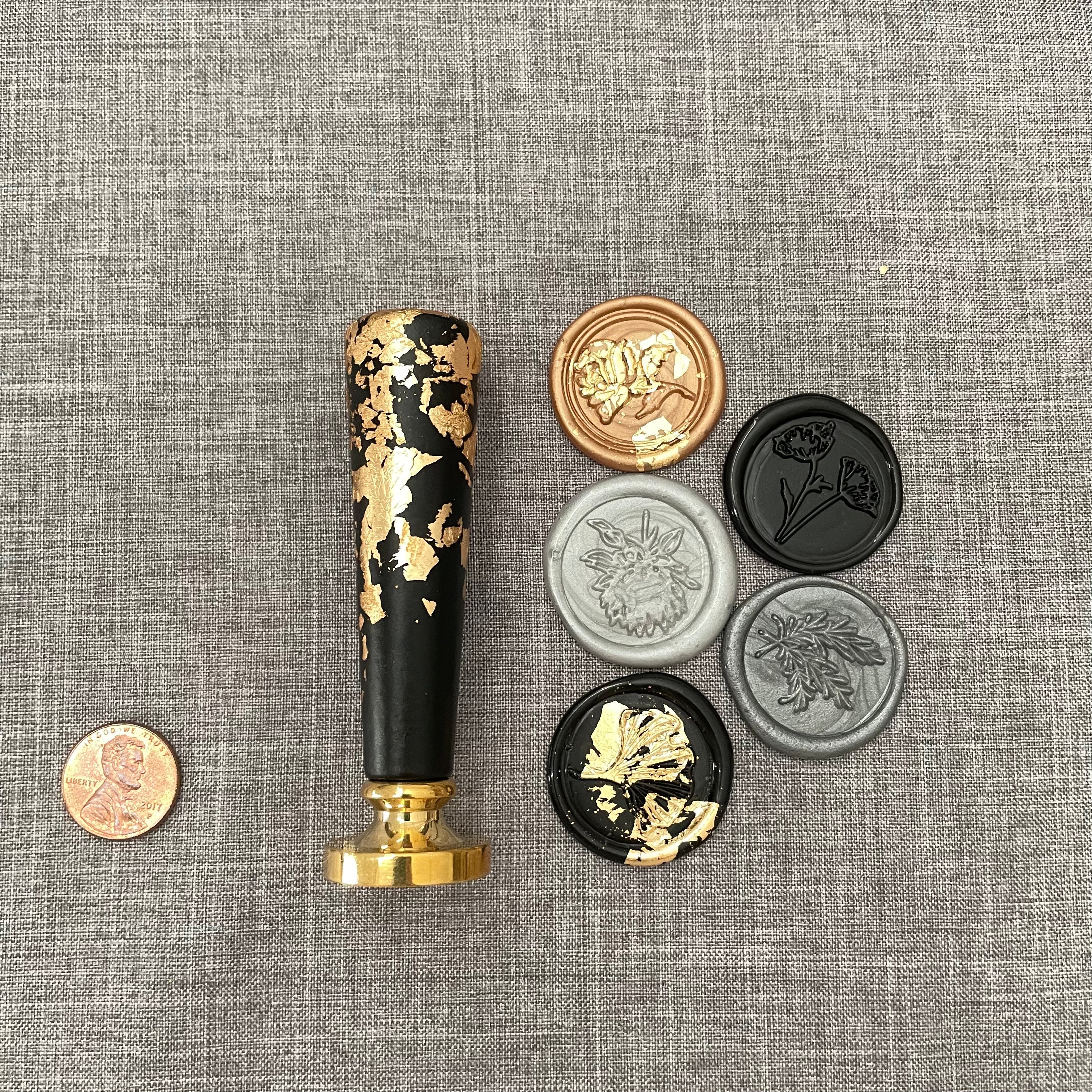 5 black, gold, and gray wax seals  with black and gold wax stamp with penny beside for size reference - Wedding Flat lay props from Champagne & GRIT