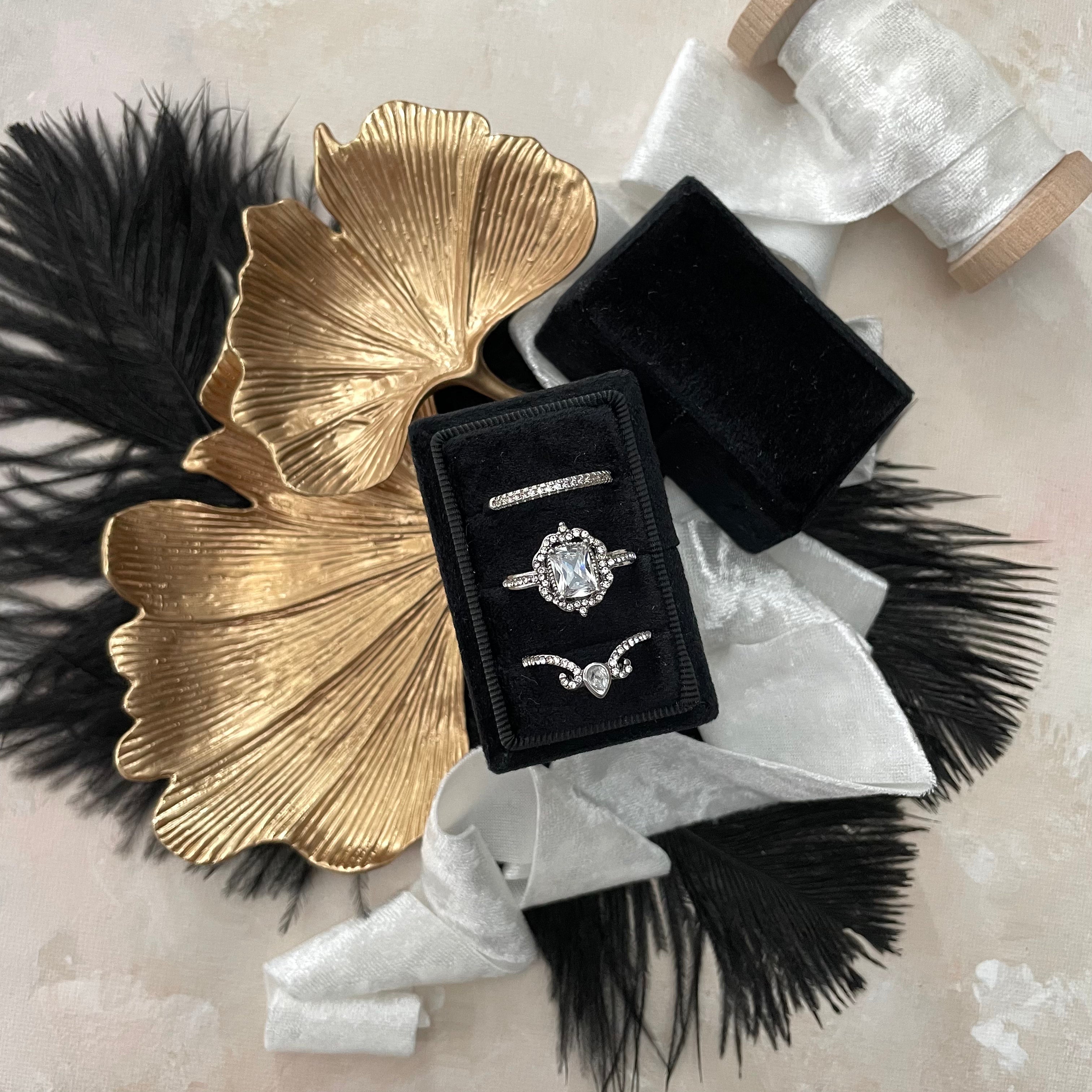 Ginkgo Leaf Gold Styling Tray styled with black ring box, silver ribbon, and black feathers - Flat Lay Props from Champagne & GRIT