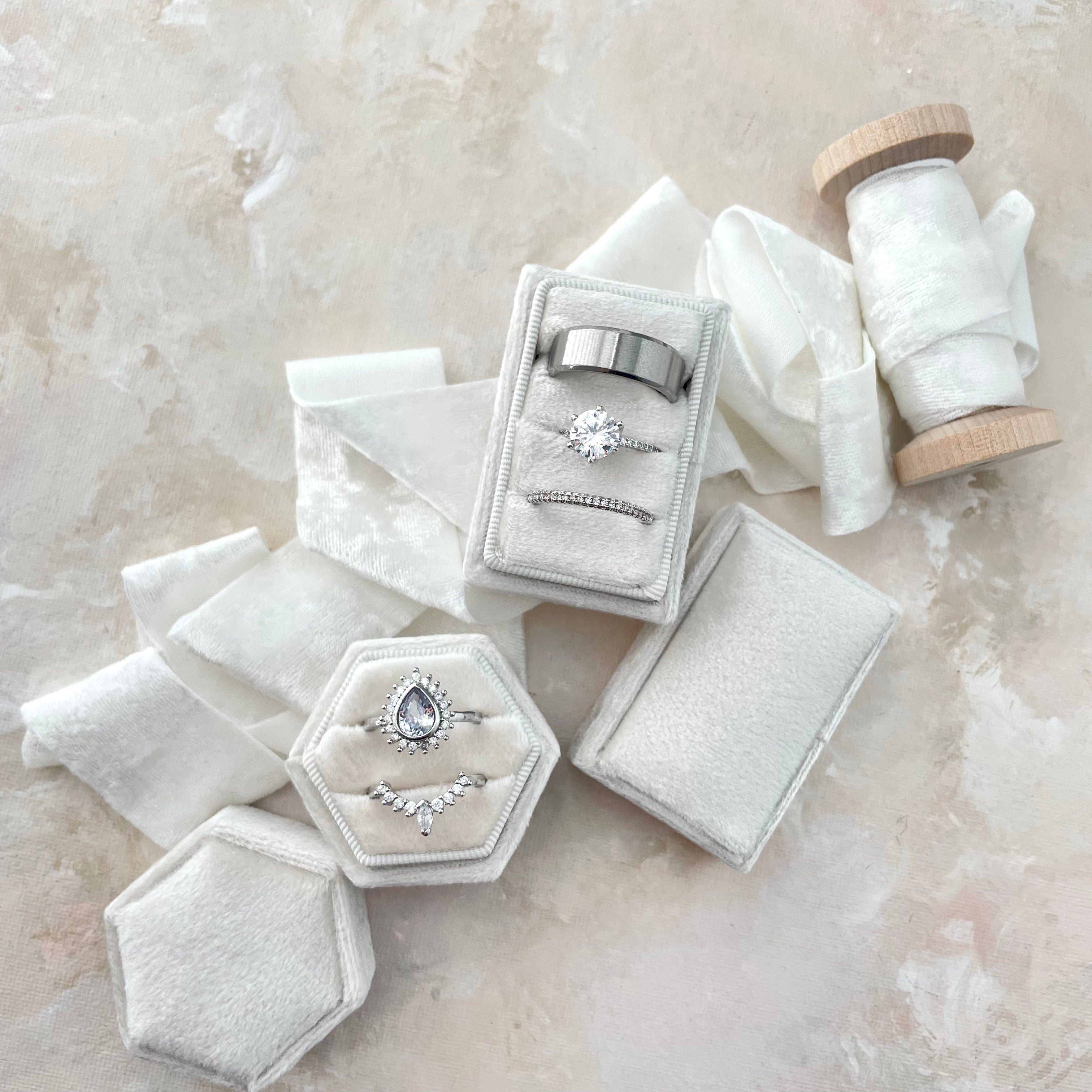 White tripe slot ring box and hexagon double slot ring box styled with ivory ribbon - Wedding Flat lay props from Champagne & GRIT