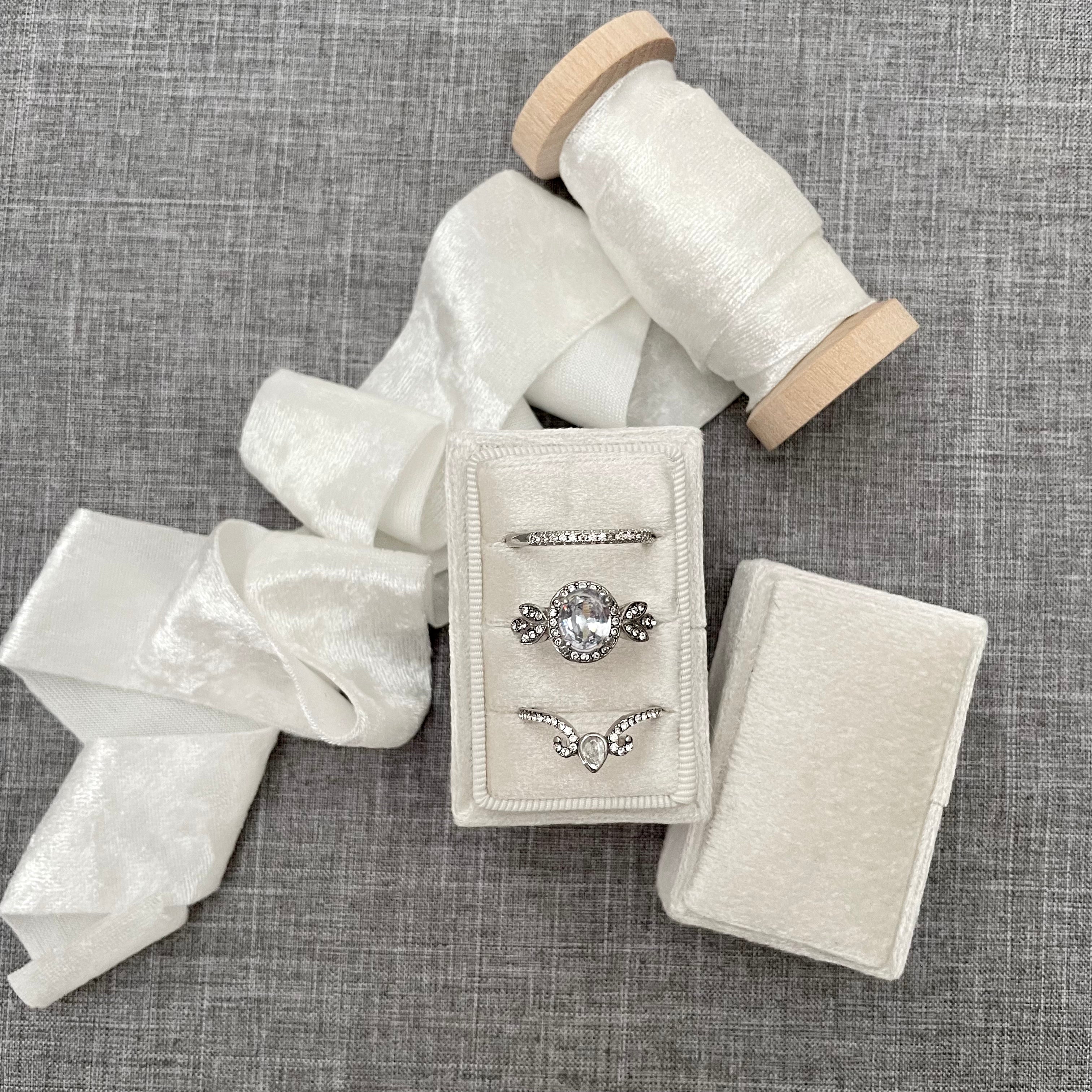 White tripe slot ring box styled with ivory velvet ribbon - Wedding Flat lay props from Champagne & GRIT