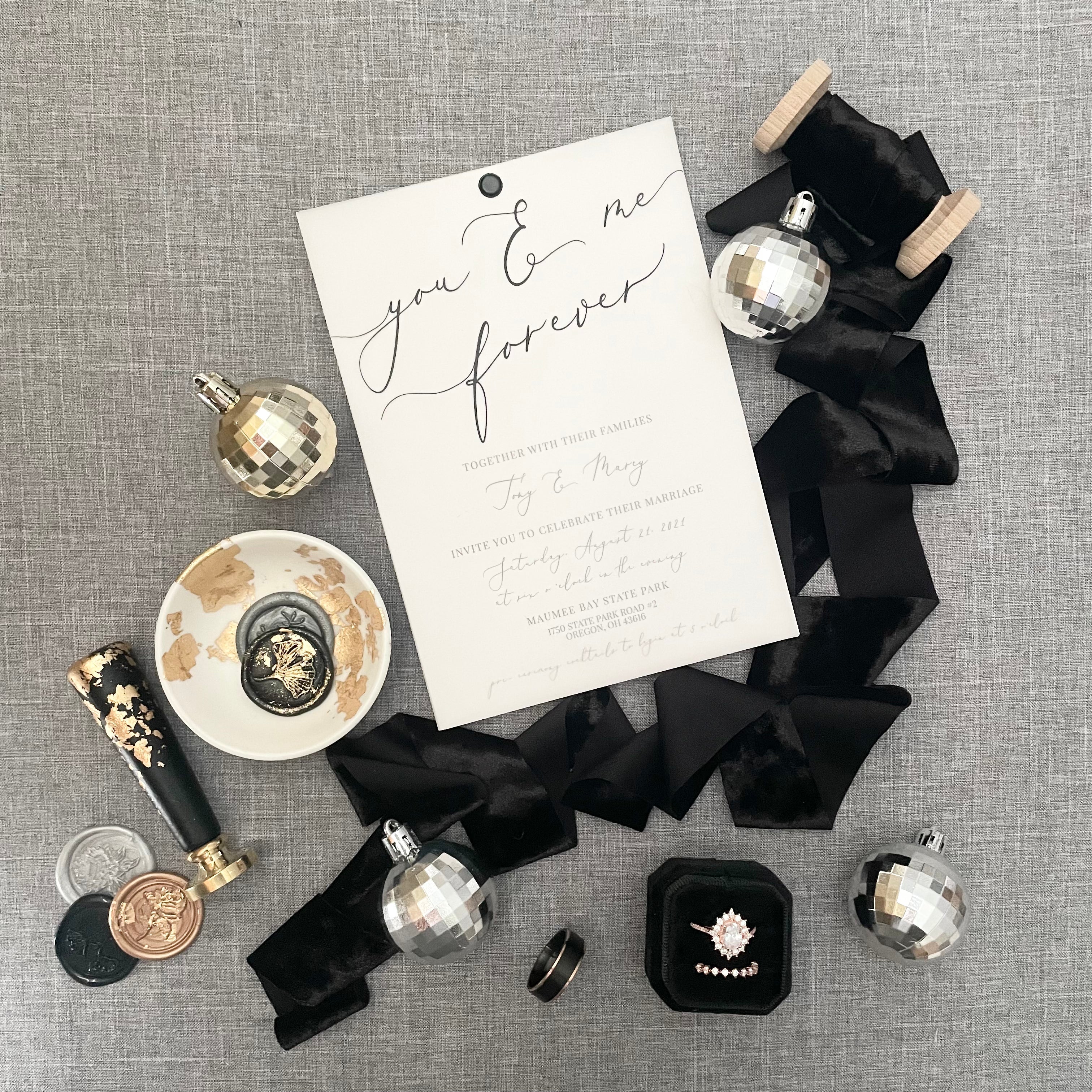 Example of how to use Black & Gold Mini Flat Lay Prop Kit styled with wedding invitation, black ring box,  and wax seal stamp - Wedding Flat lay props from Champagne & GRIT