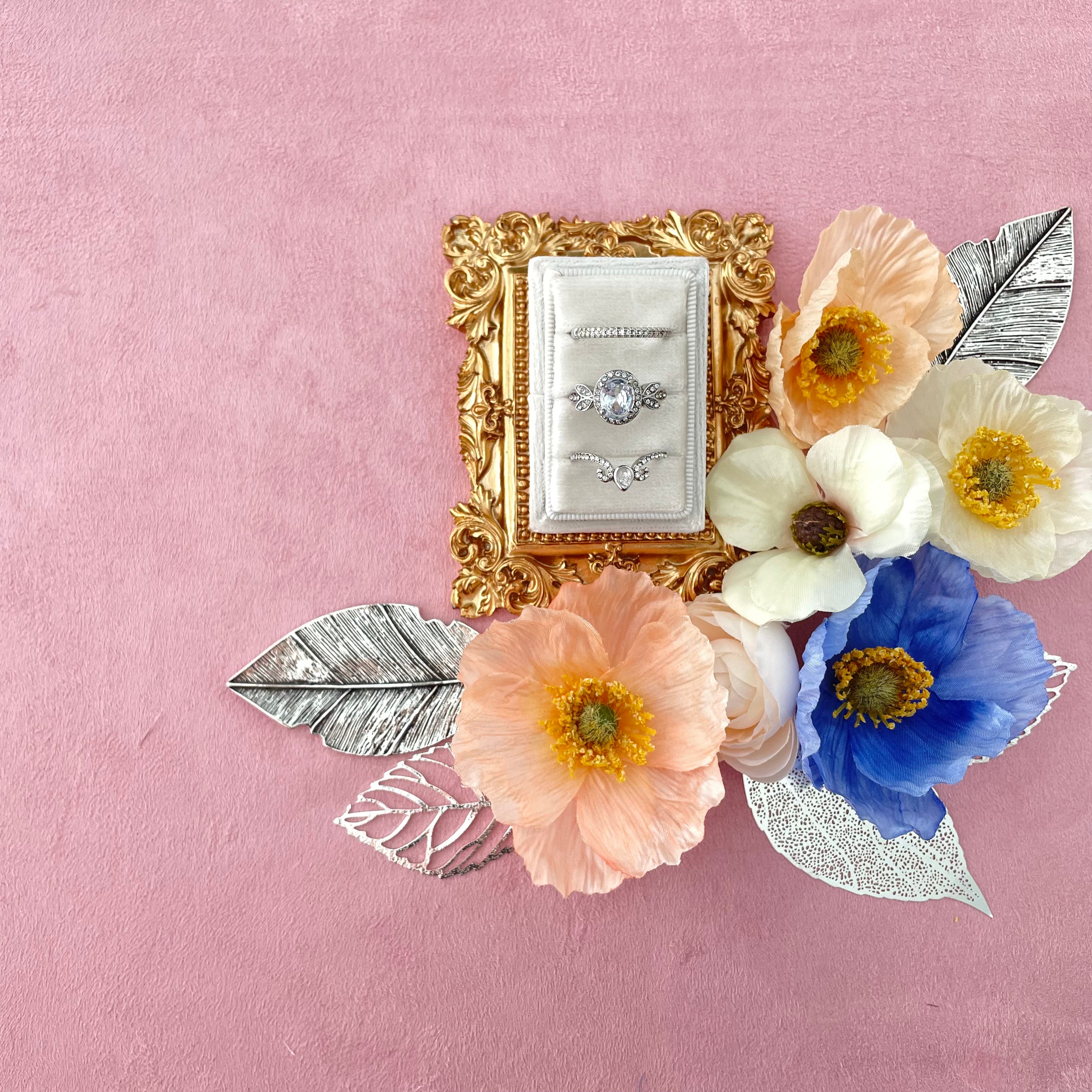 White triple slot ring box on vintage gold tray styled with variety of colored florals  - Wedding Flat lay props from Champagne & GRIT