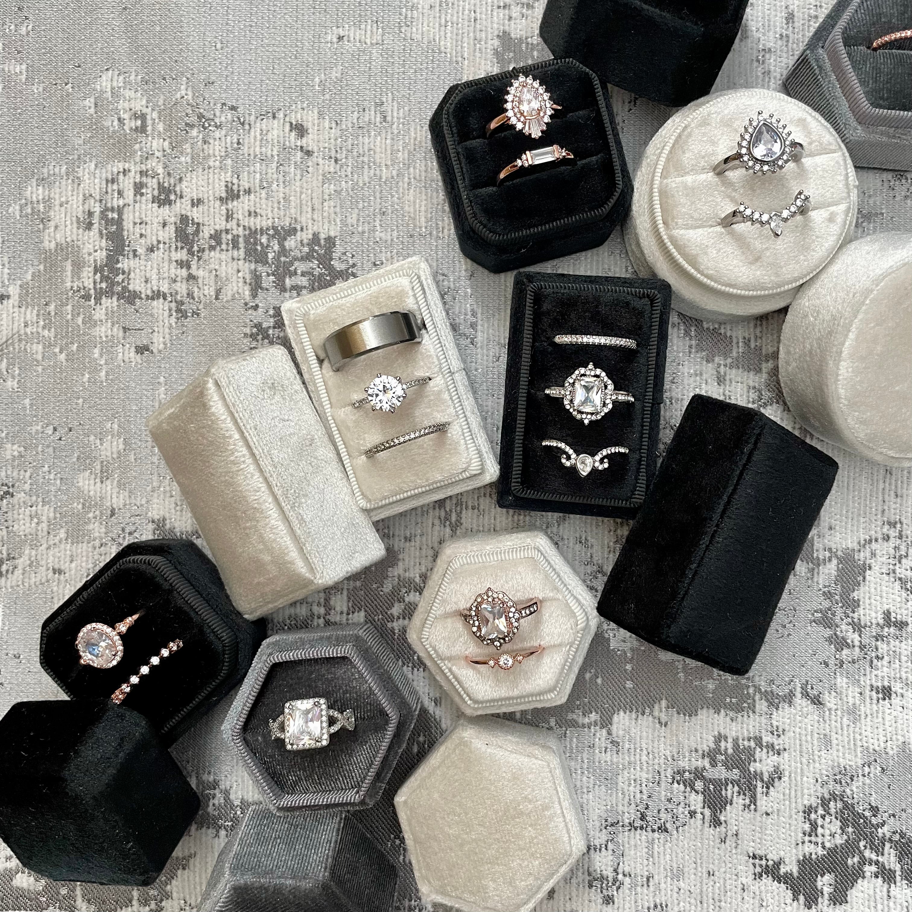 Black triple ring box beside other Velvet ring boxes  - Flat Lay Props from Champagne & GRIT