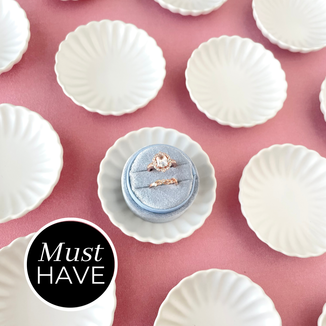 Matte white scalloped dish with dusty blue ring box must have styling props from Champagne & GRIT