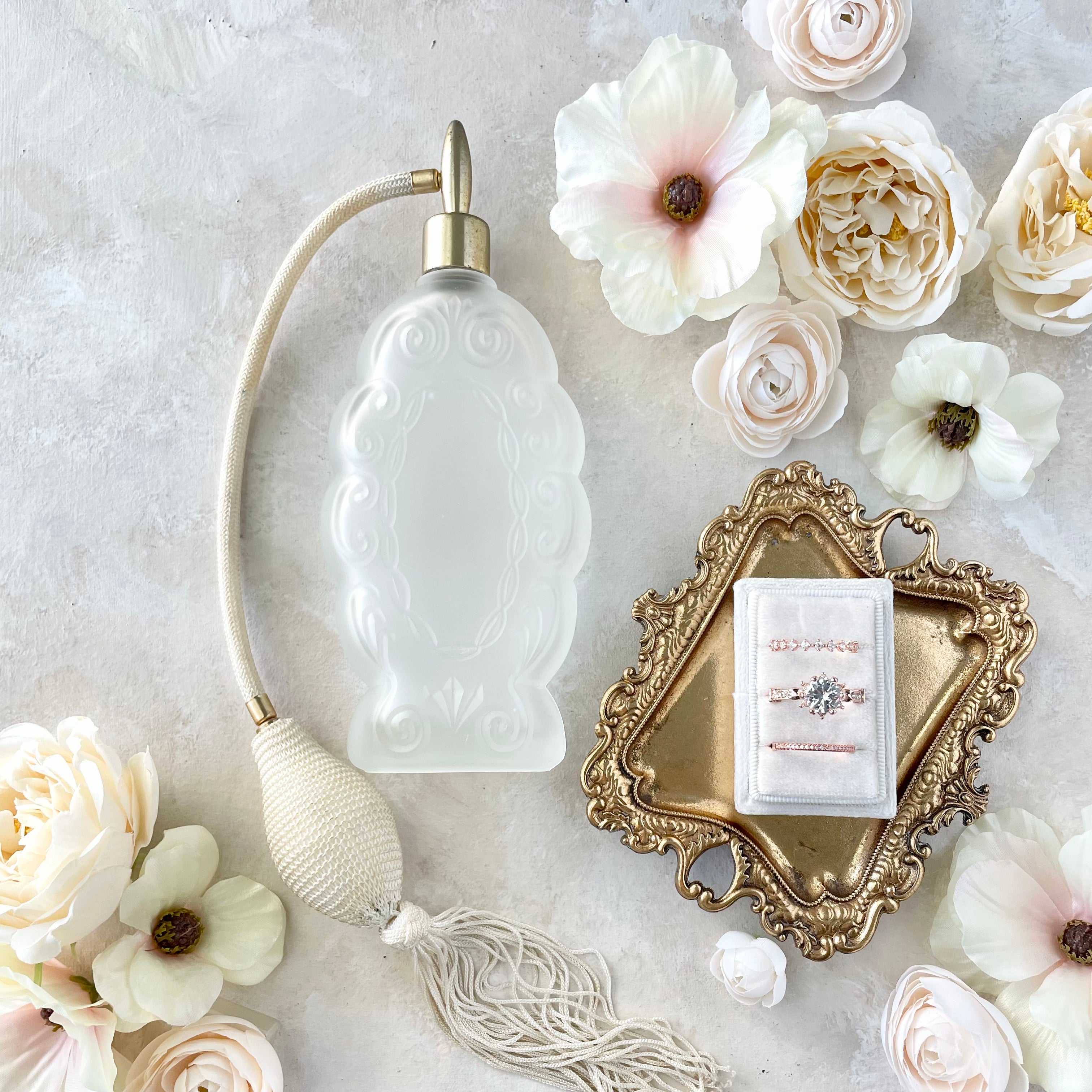 Gold vintage tray for wedding flay lay with white 3 slot ring box, white florals and vintage perfume bottle - Flat Lay Props from Champagne & GRIT