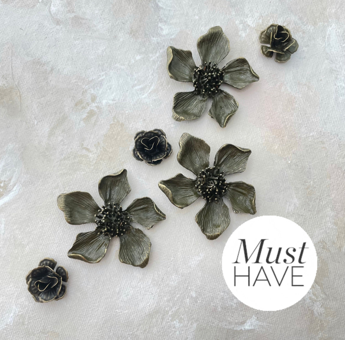  Three large Metal styling flowers and three small metal styling flowers, flowers have a  Brown Finish with touches of gold must have styling props from Champagne & GRIT