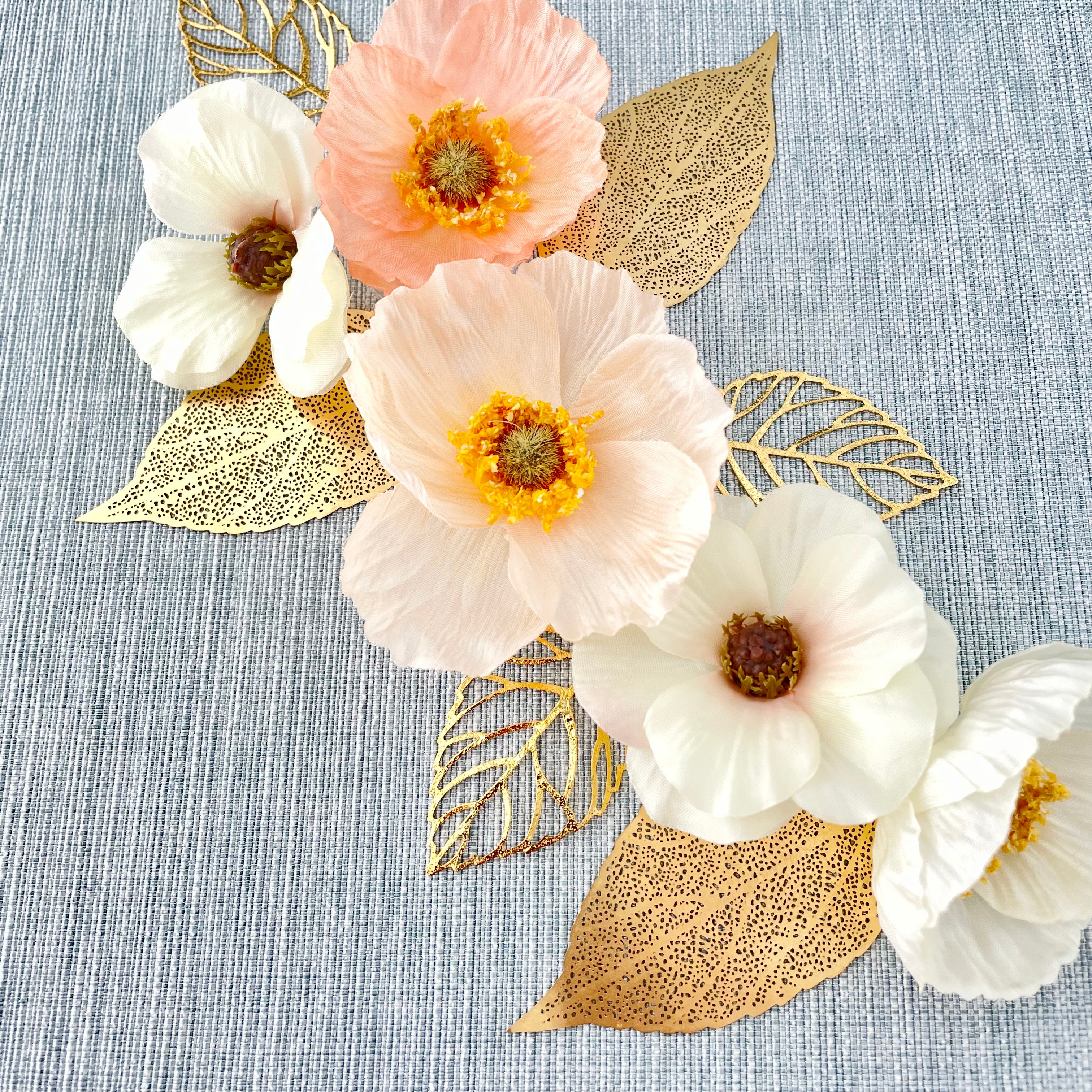 6 styling leaves including 3 gold leaves, 3 gold leaves that are larger with 5 florals placed on top - wedding flat lay props from Champagne & GRIT