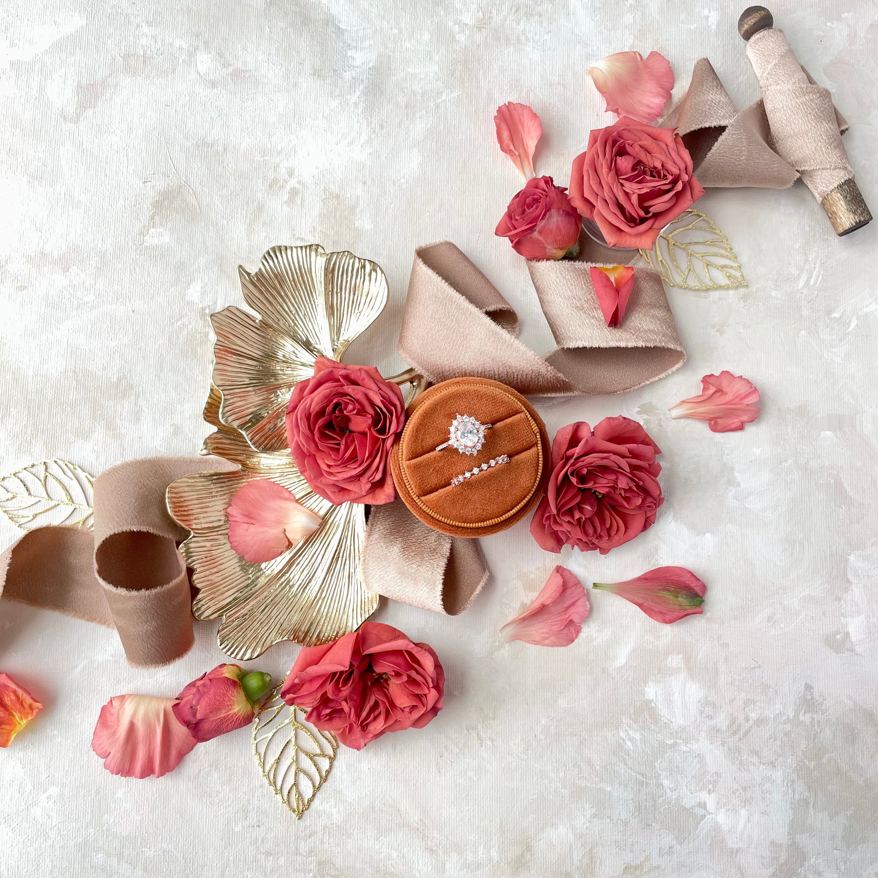 Ginkgo Leaf Gold Styling Tray styled with burnt orange ring box, tan ribbon, and cranberry colored florals - Flat Lay Props from Champagne & GRIT