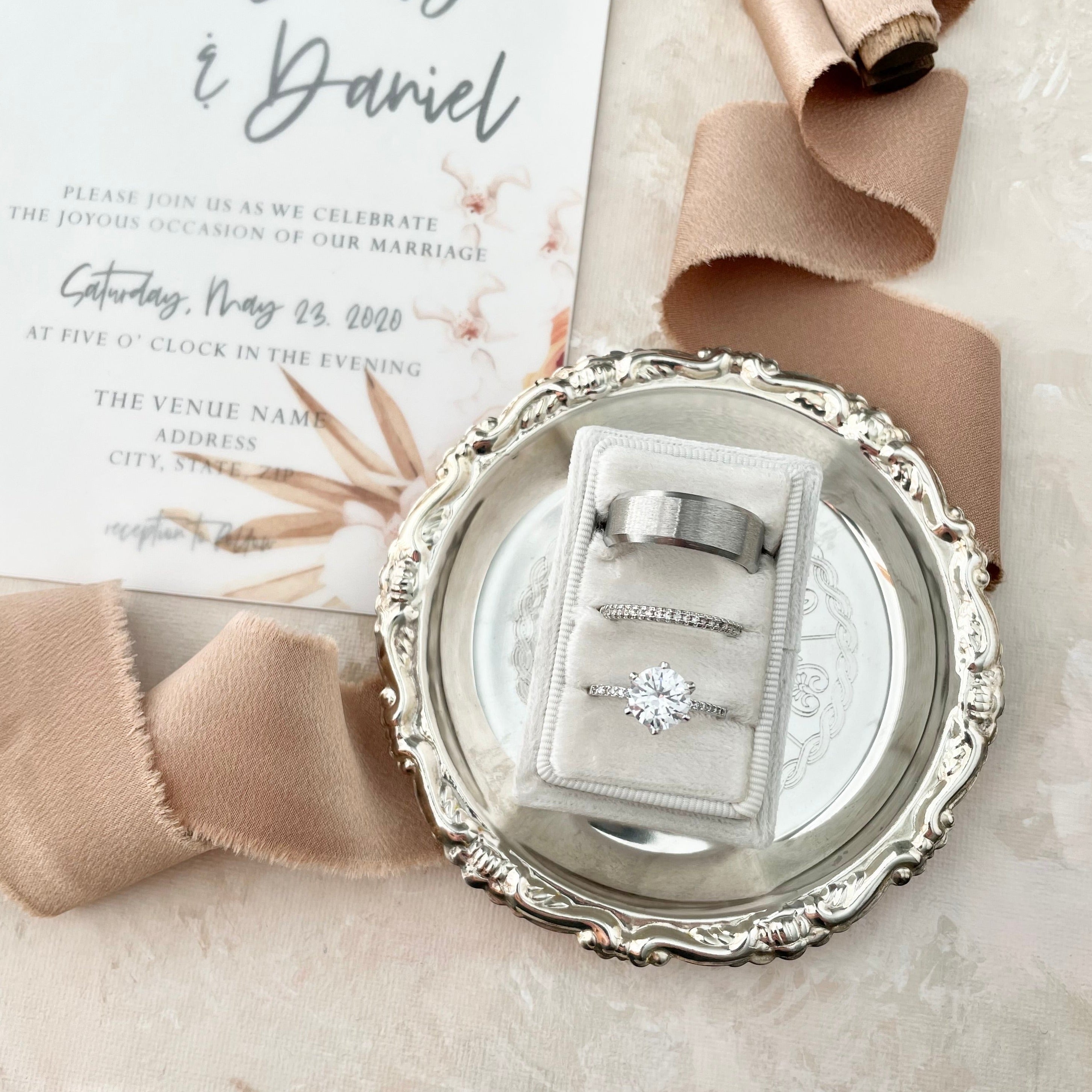 Small vintage silver ring dish with 3 slot ring box styled with neutral ribbon and floral wedding invitation - Wedding Flat lay props from Champagne & GRIT